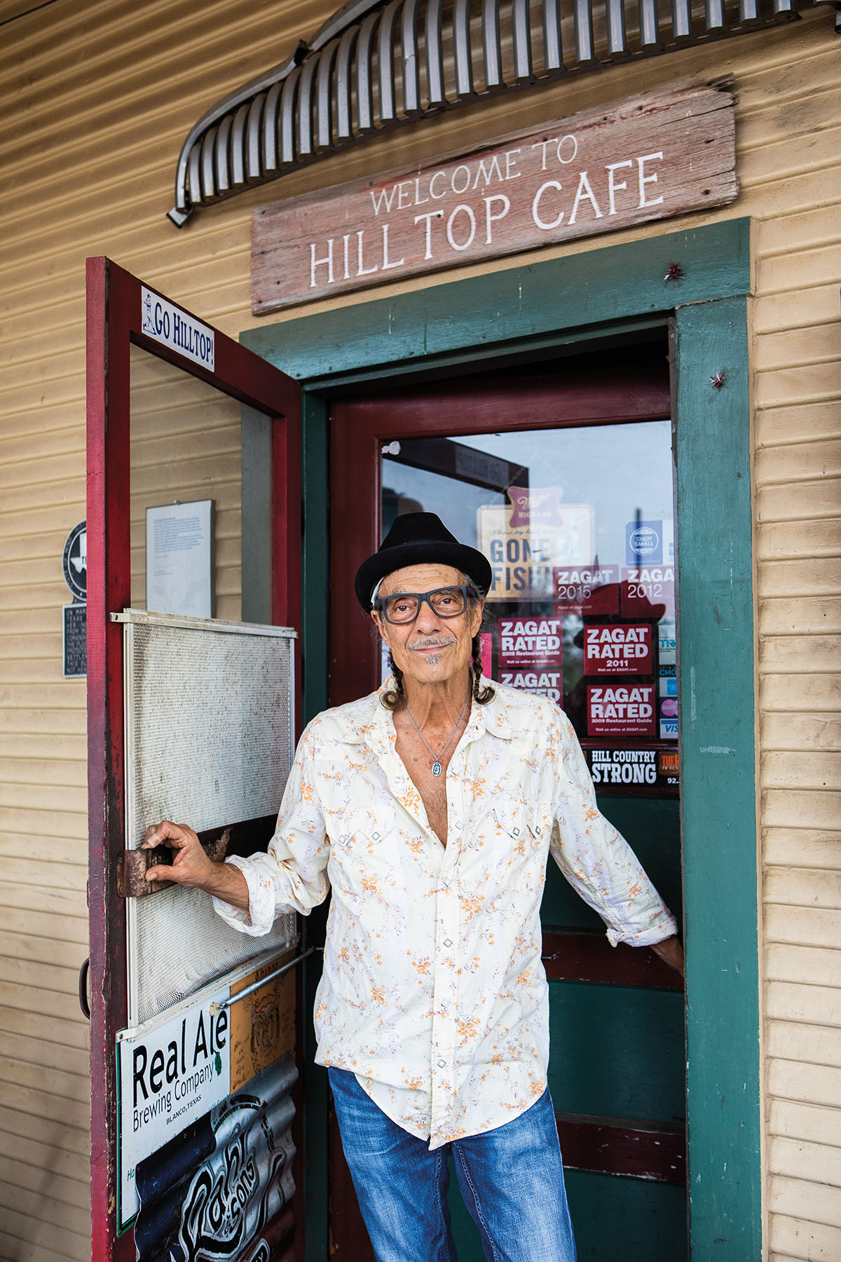 Johnny Nicholas (owner) stand outside of Hill Top Cafe