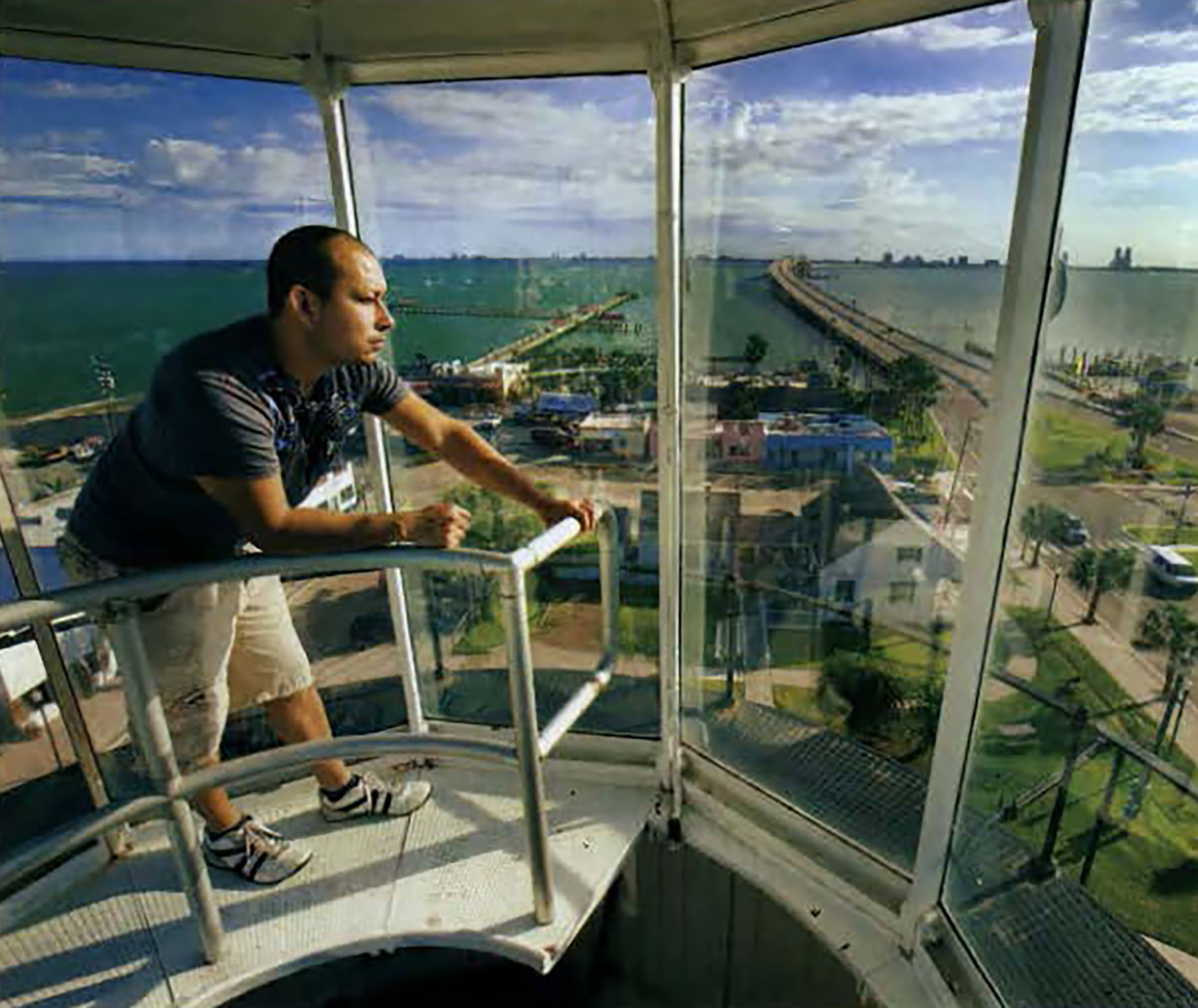 A man looking at the view from the top of the Port Isabel Lighthouse.