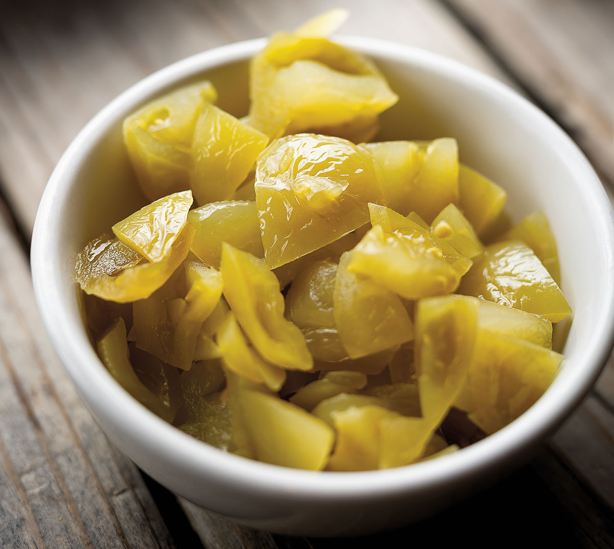 Photo of green tomato relish in a white bowl