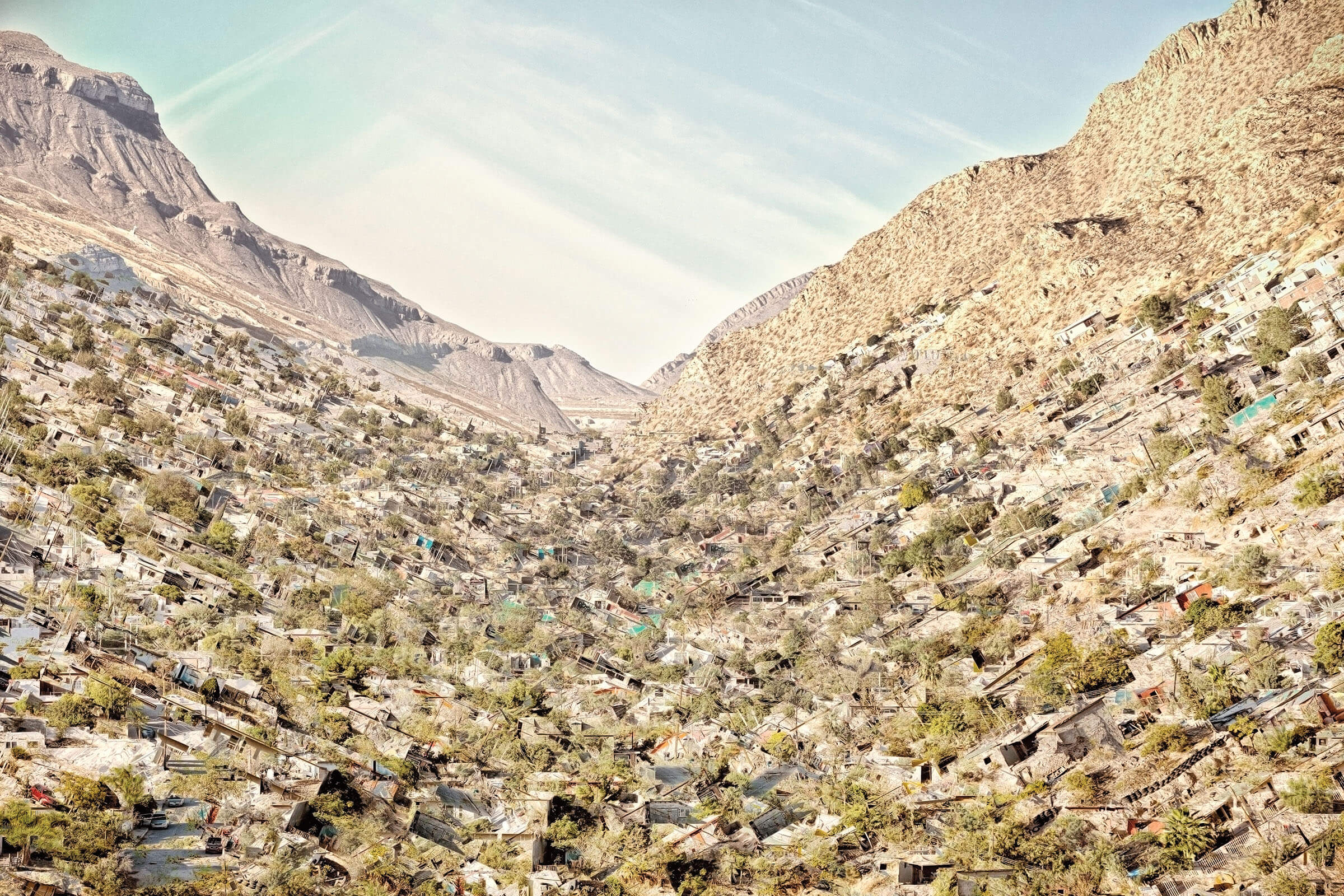 A composite image of houses and trees caving in in front of a desert landscape