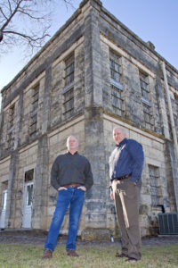 Curators of the Old Jail Museum stand outside of the historic building