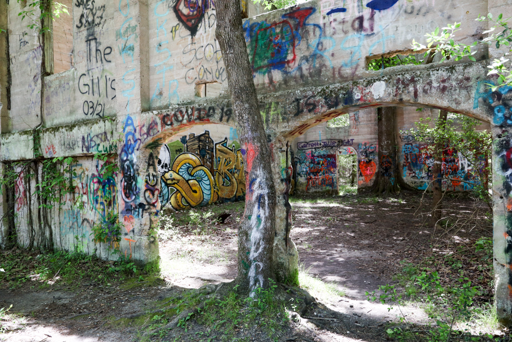 Graffiti covers the ruins of an old sawmill 