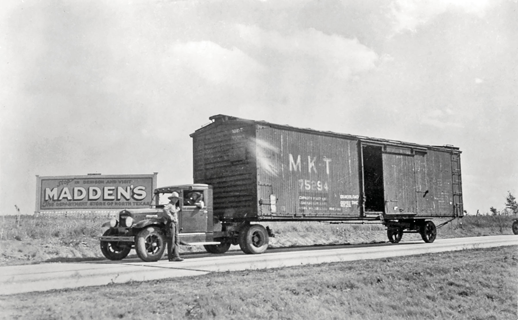 An old photograph of an early semi truck