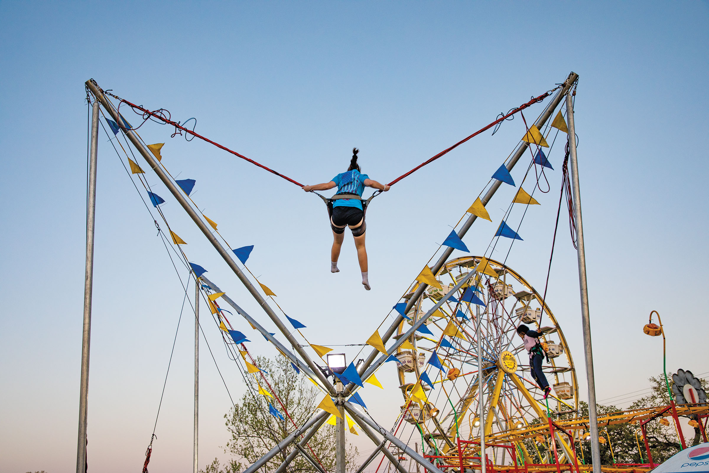 A person swings on a carnival ride