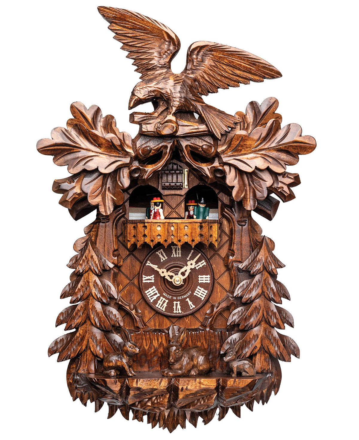 An intracate wooden cuckoo clock with a large bird on top