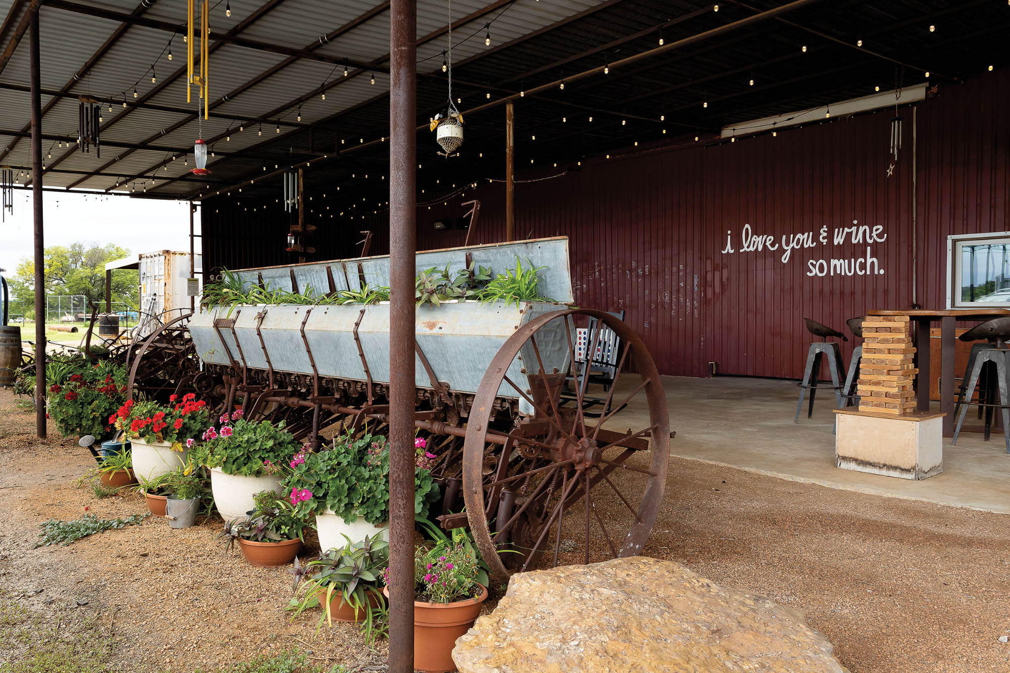 Rustic digs at a winery featuring a mural saying "I Love Wine So Much"