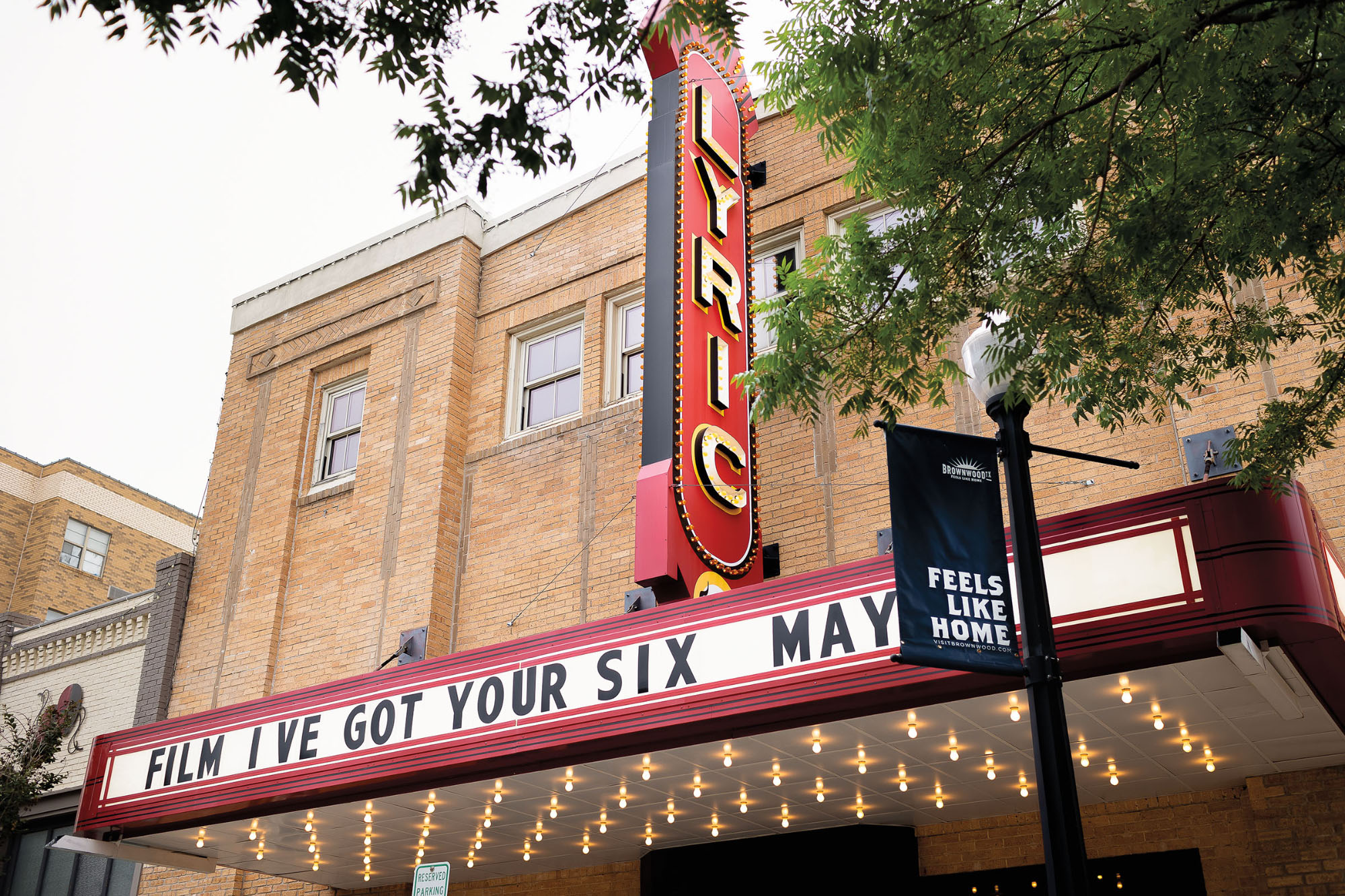 The red and gold marquee of a theater reading "Lyric"