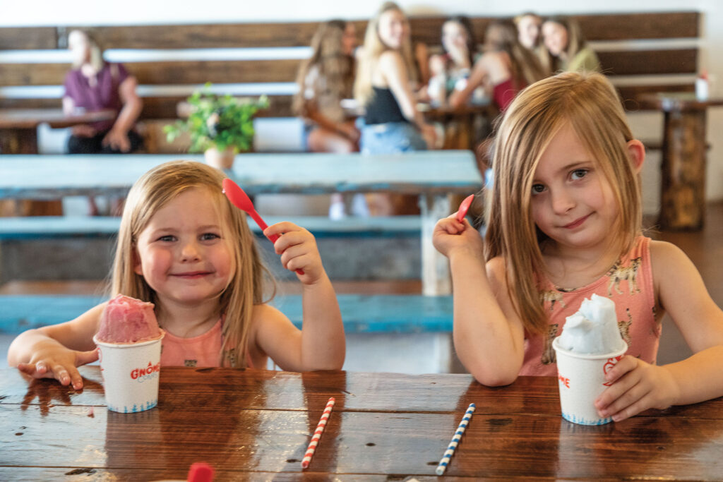 Two little girls eating snow cones