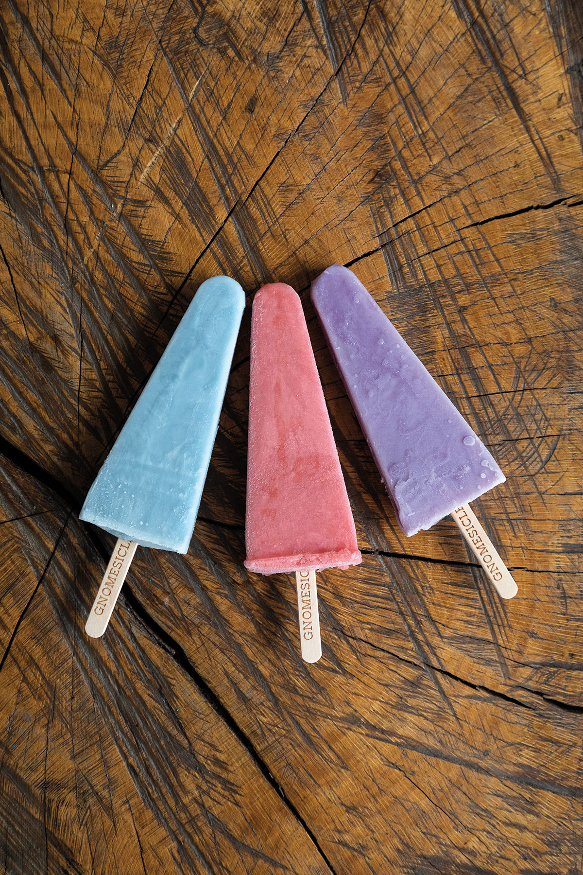 A blue, red, and purple triangle shaped popsicle.