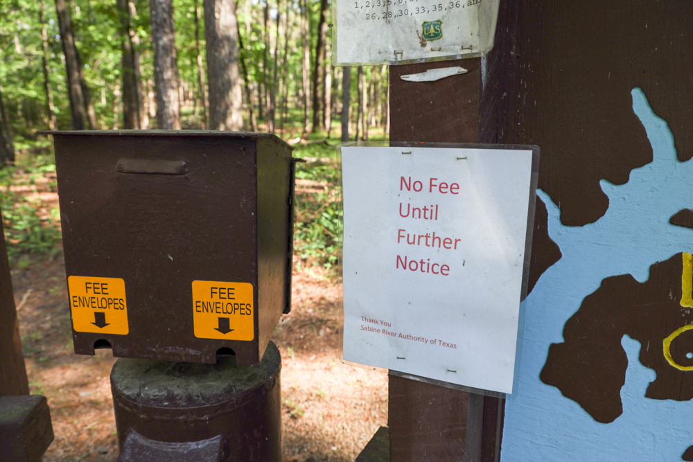 A sign reading "No Fees Until Further Notice" at the entrance to Sabine National Forest
