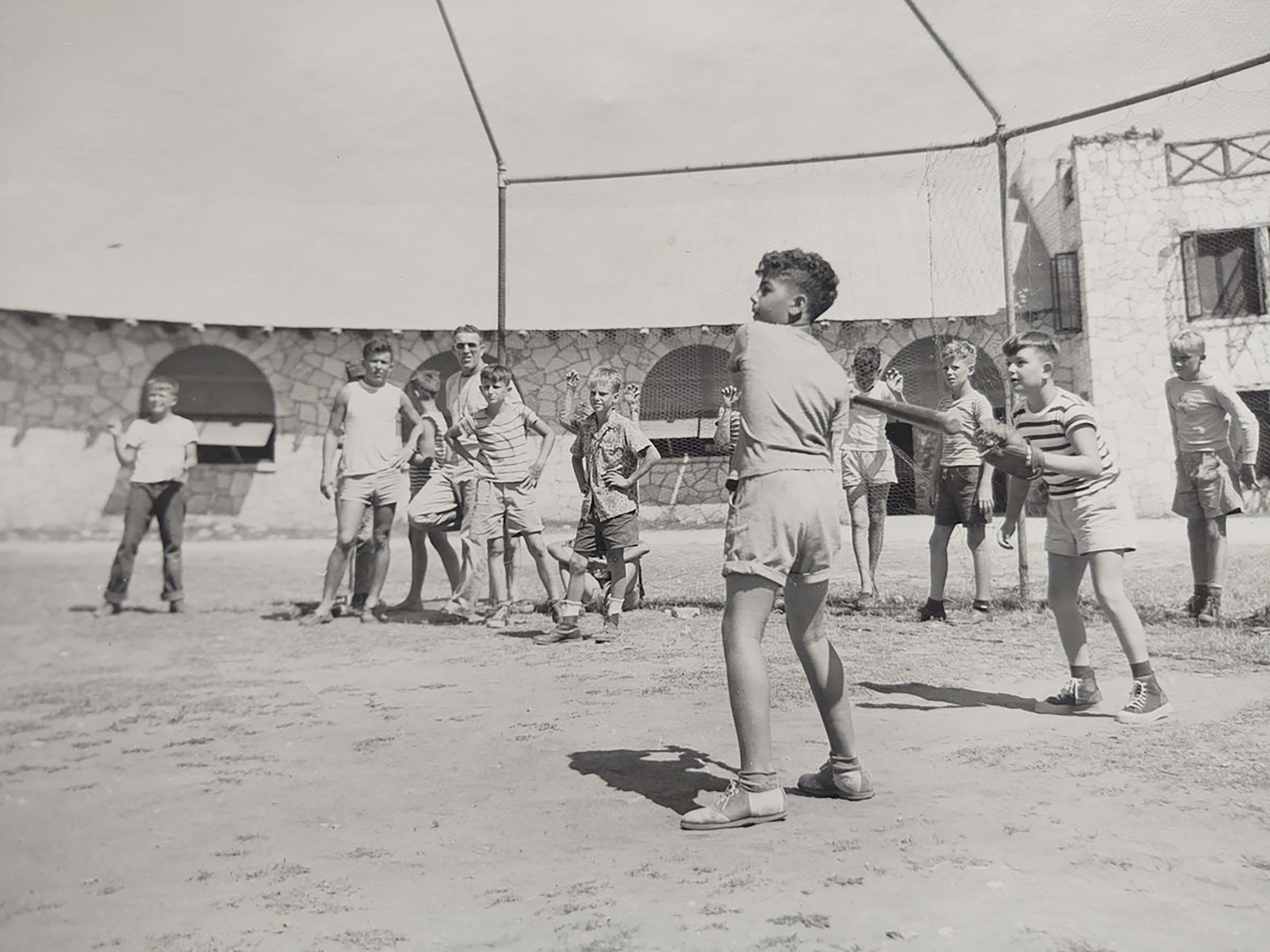 Vintage photo of boys playing baseball at summer camp