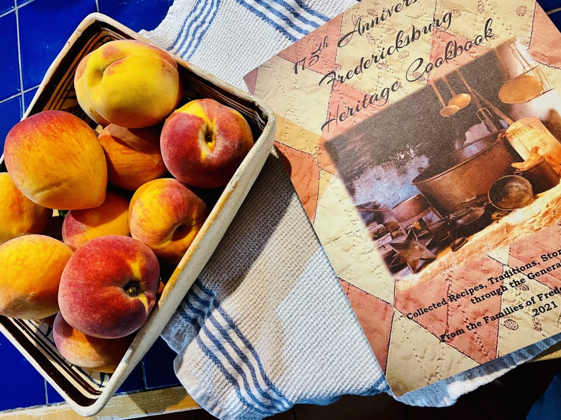 cookbook and peaches on a napkin on the table