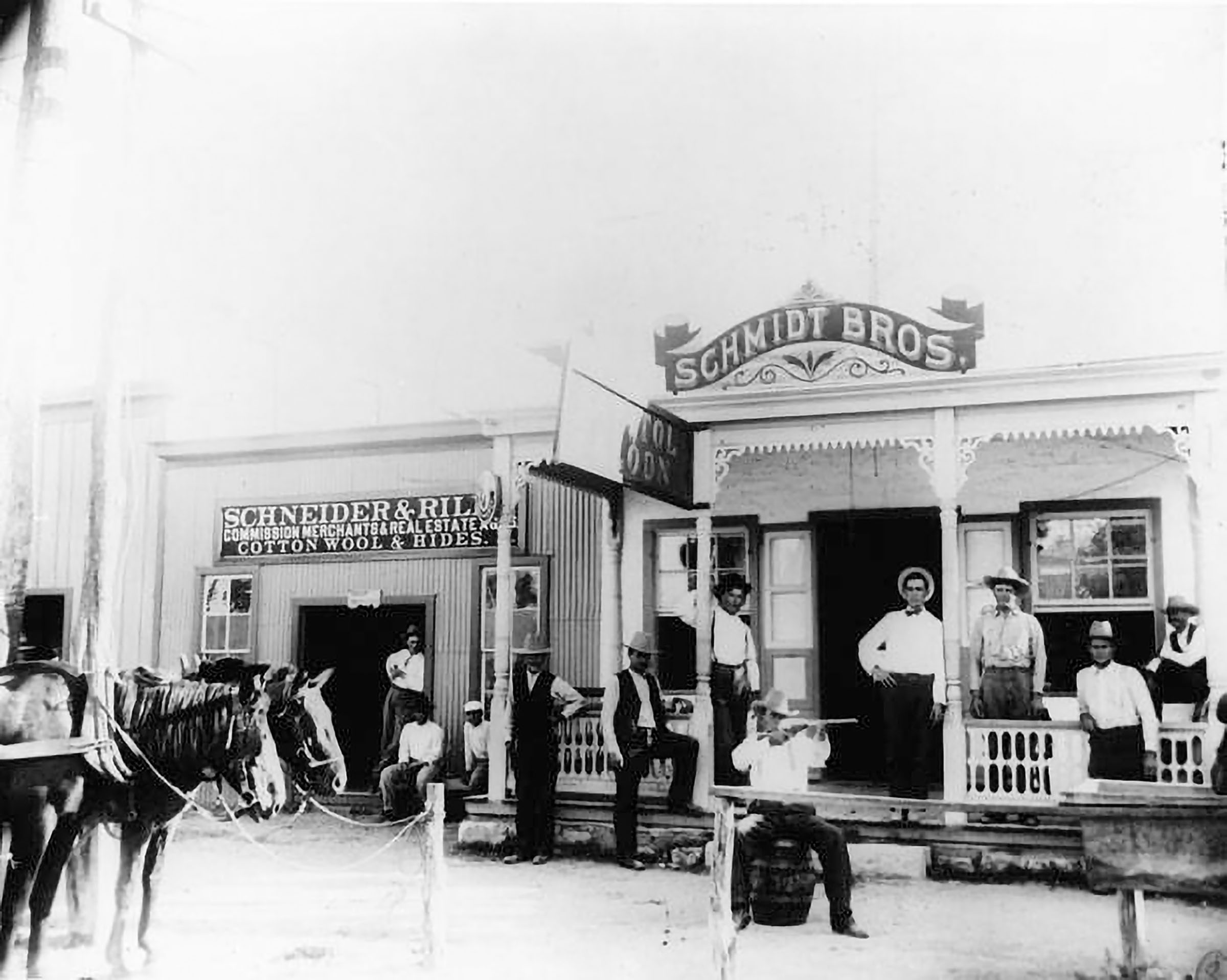 A group of men stand around the porch of a bar