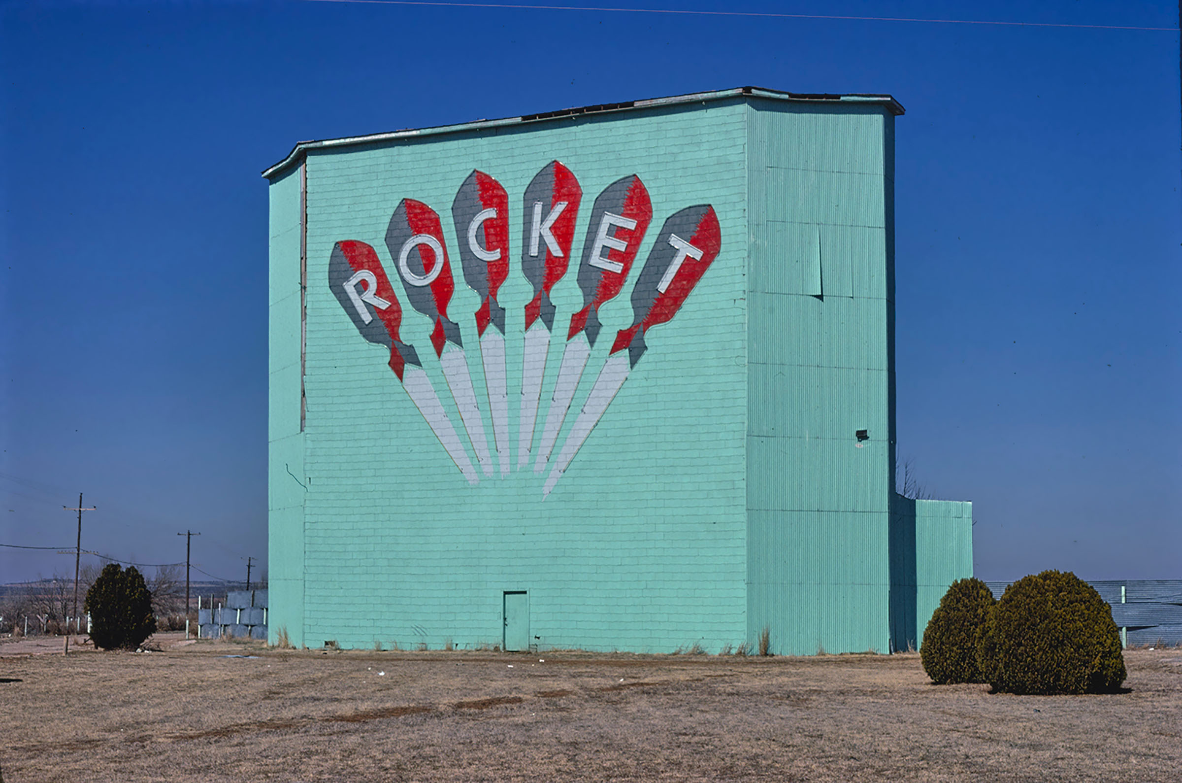A turquoise building with the word 'ROCKET' on the side in tall white letters