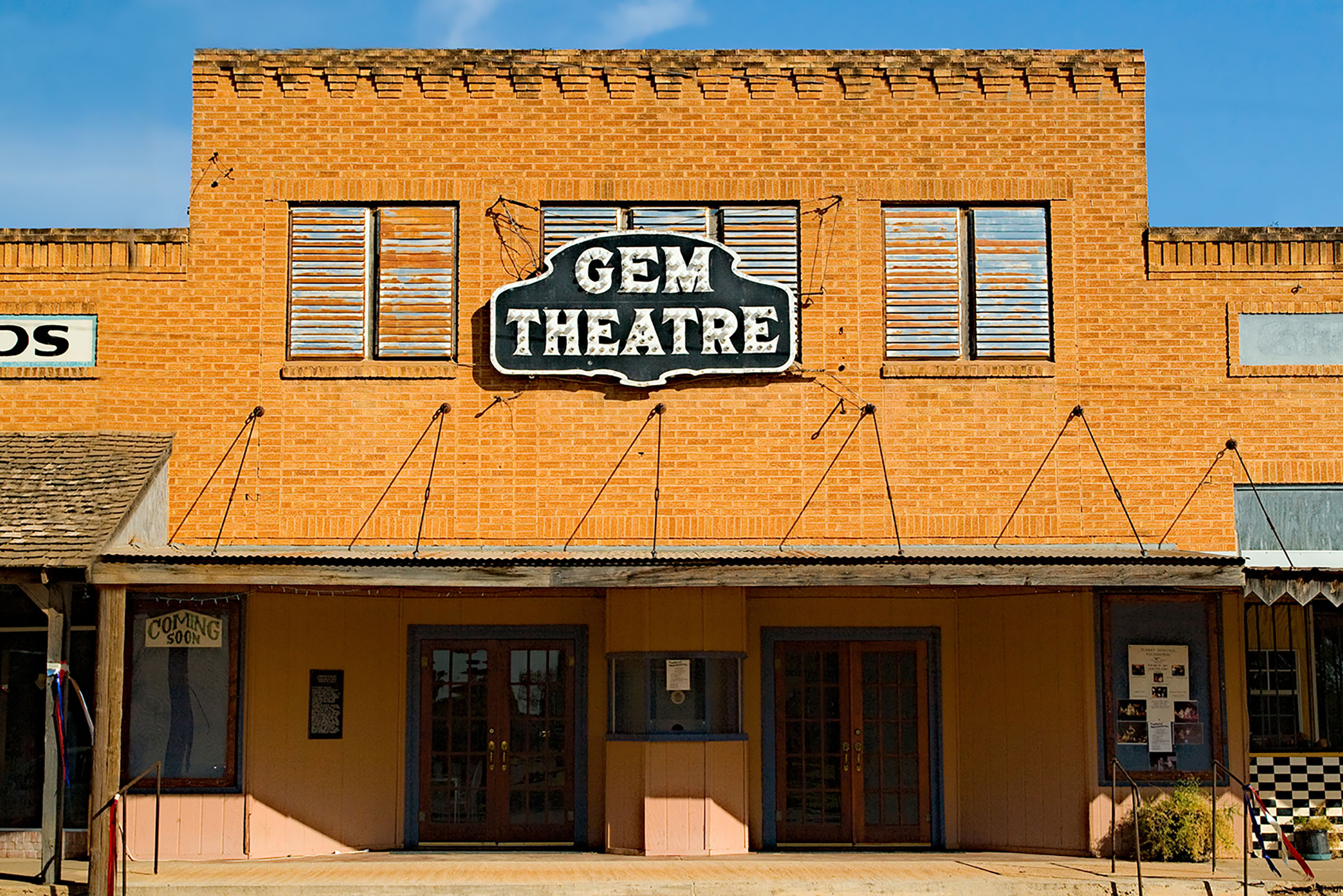The outside of a brick building reading 'Gem Theater'
