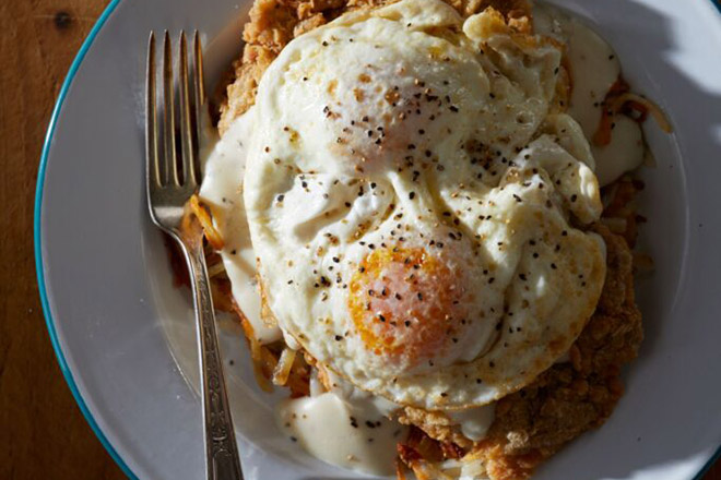 An overhead view of eggs on top of chicken-fried steak