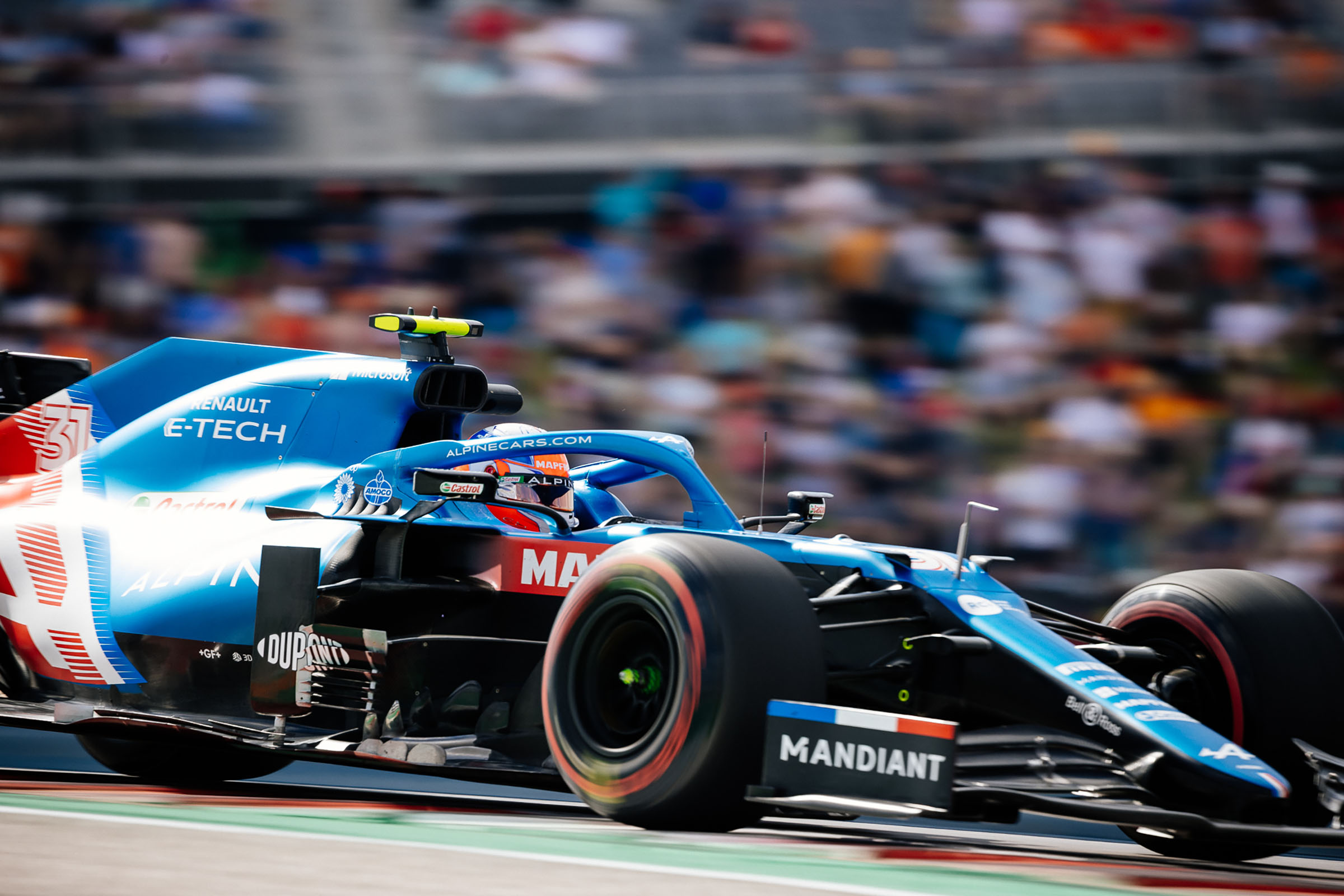 A blue car with a label reading 'Mandiant' drives by the camera