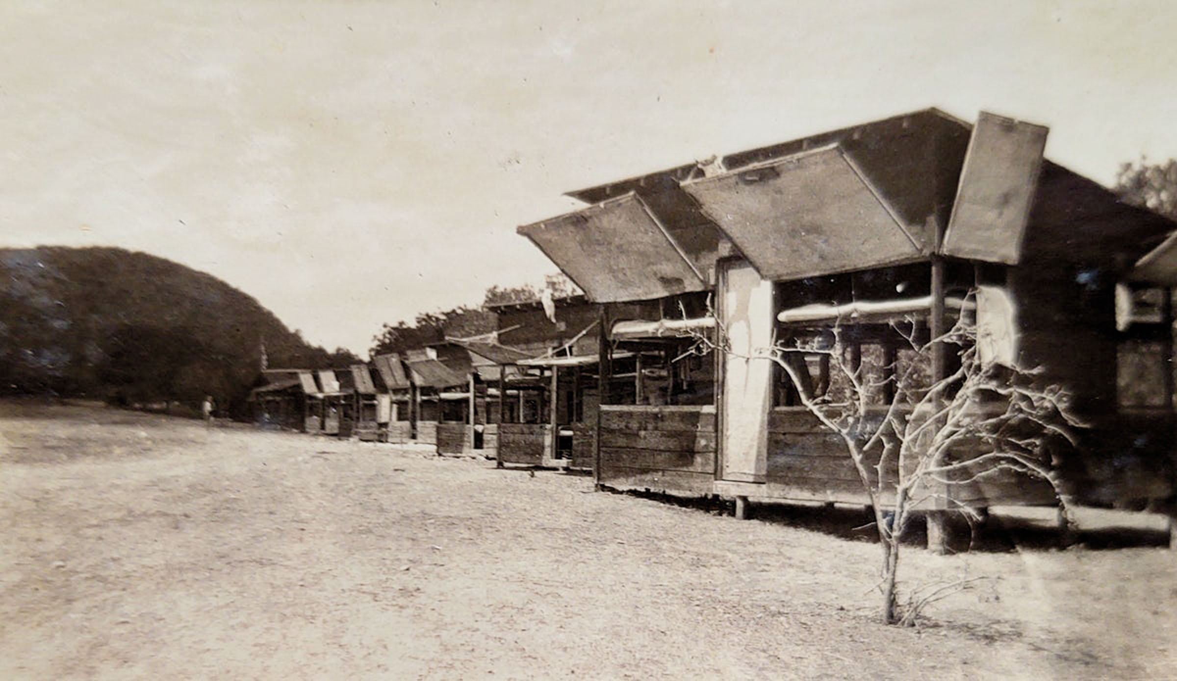 A historic picture of buildings with a sloped upward roof