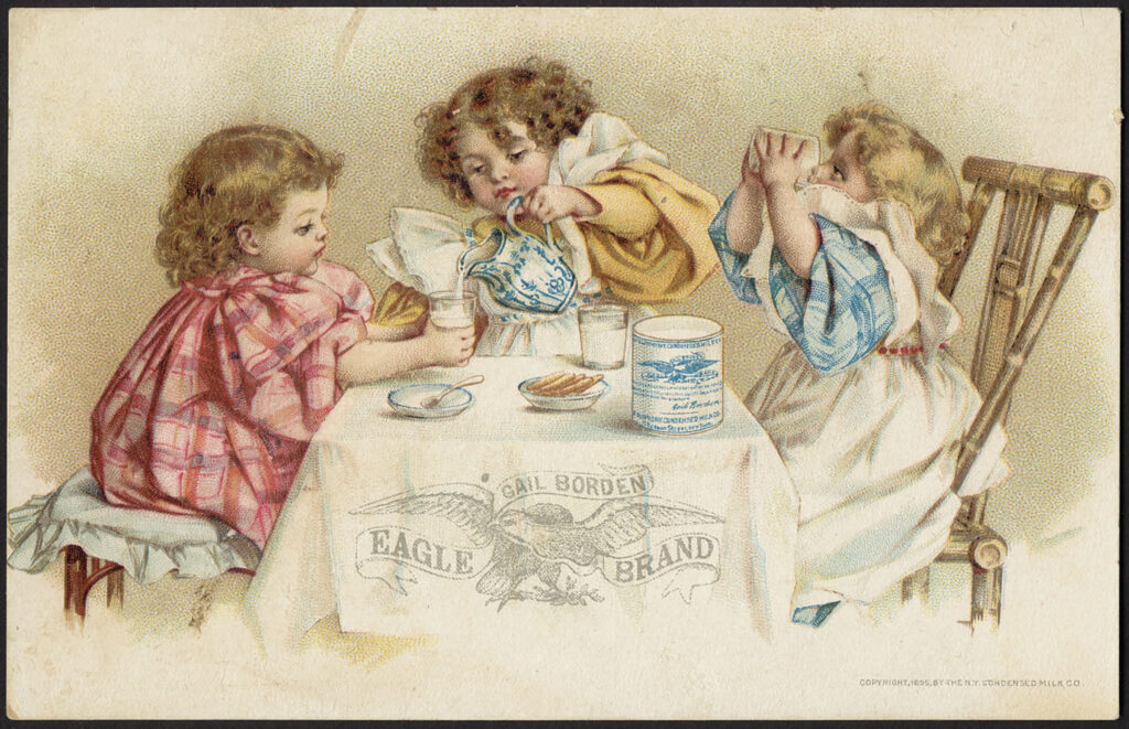 An advertisement of three children dressed in pink, yellow and blue pouring condensed milk into cups and drinking it at a table with a white tablecloth reading "Gail Borden Eagle Brand"