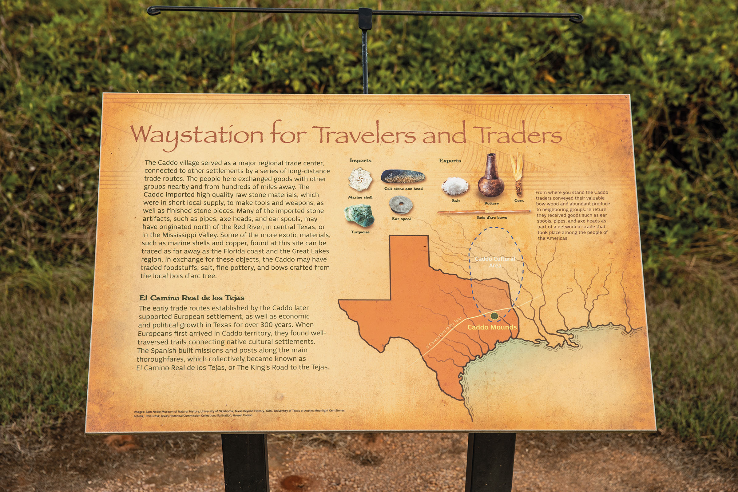 A tan sign reading "Waystation for Travelers and Traders"