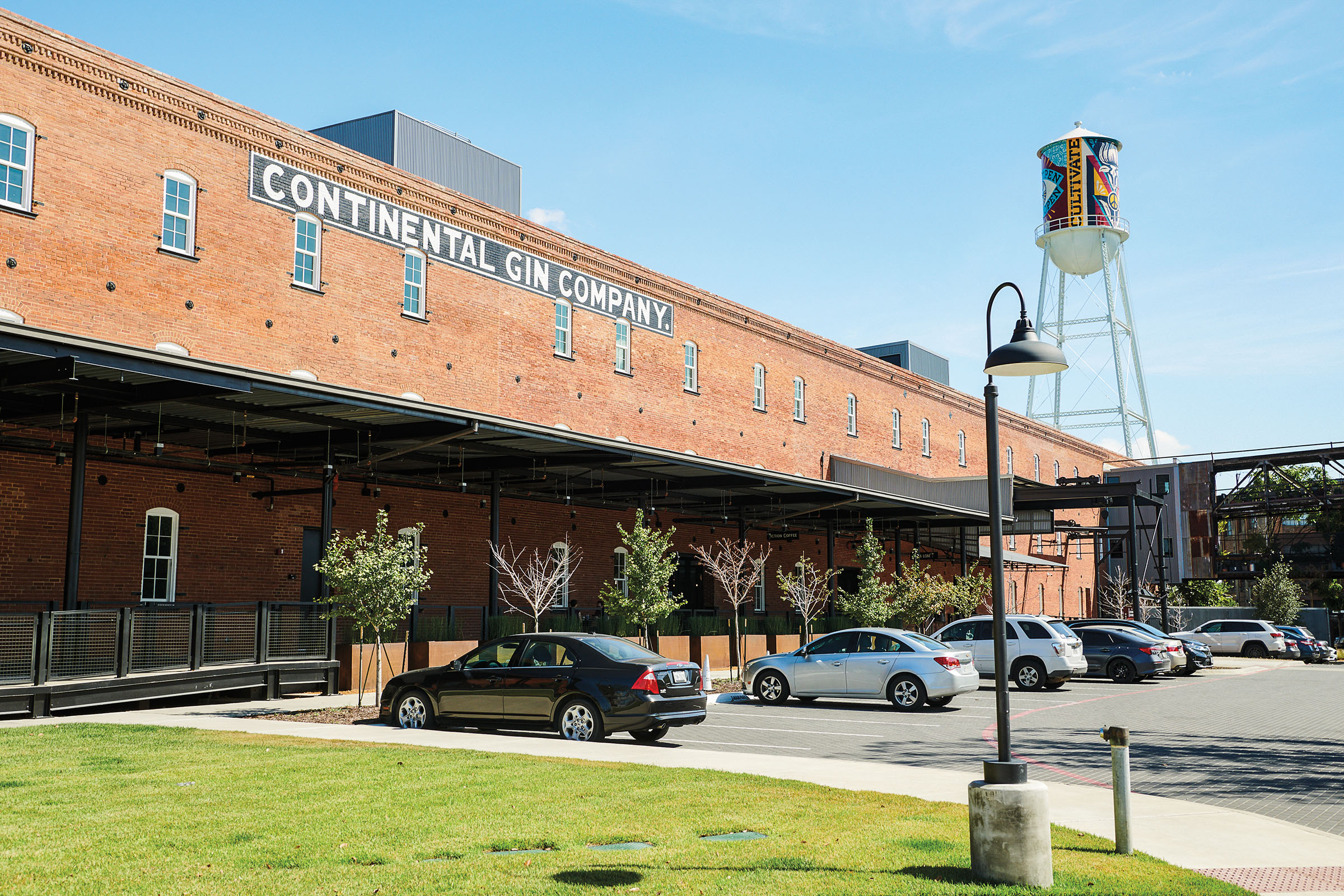 The outside of a brick building with a large sign reading "Continental Gin Company"
