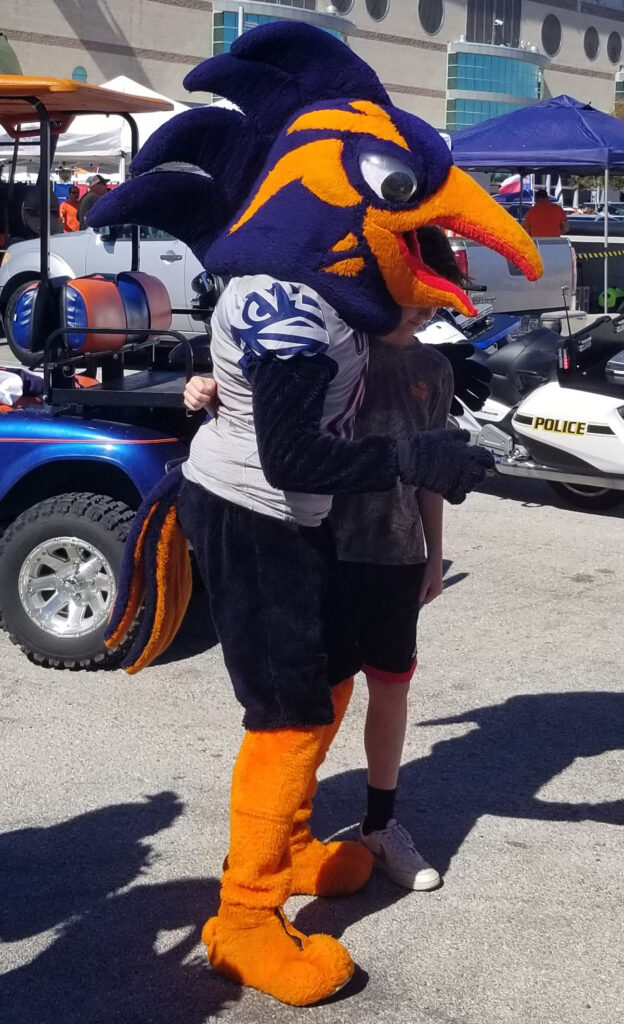 Rowdy Roadrunner stands in an orange and blue costume
