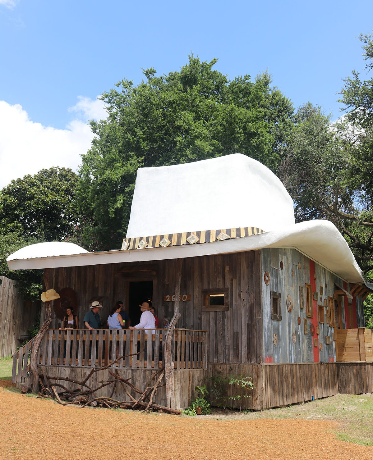 The outside of a house with a large white hat on top