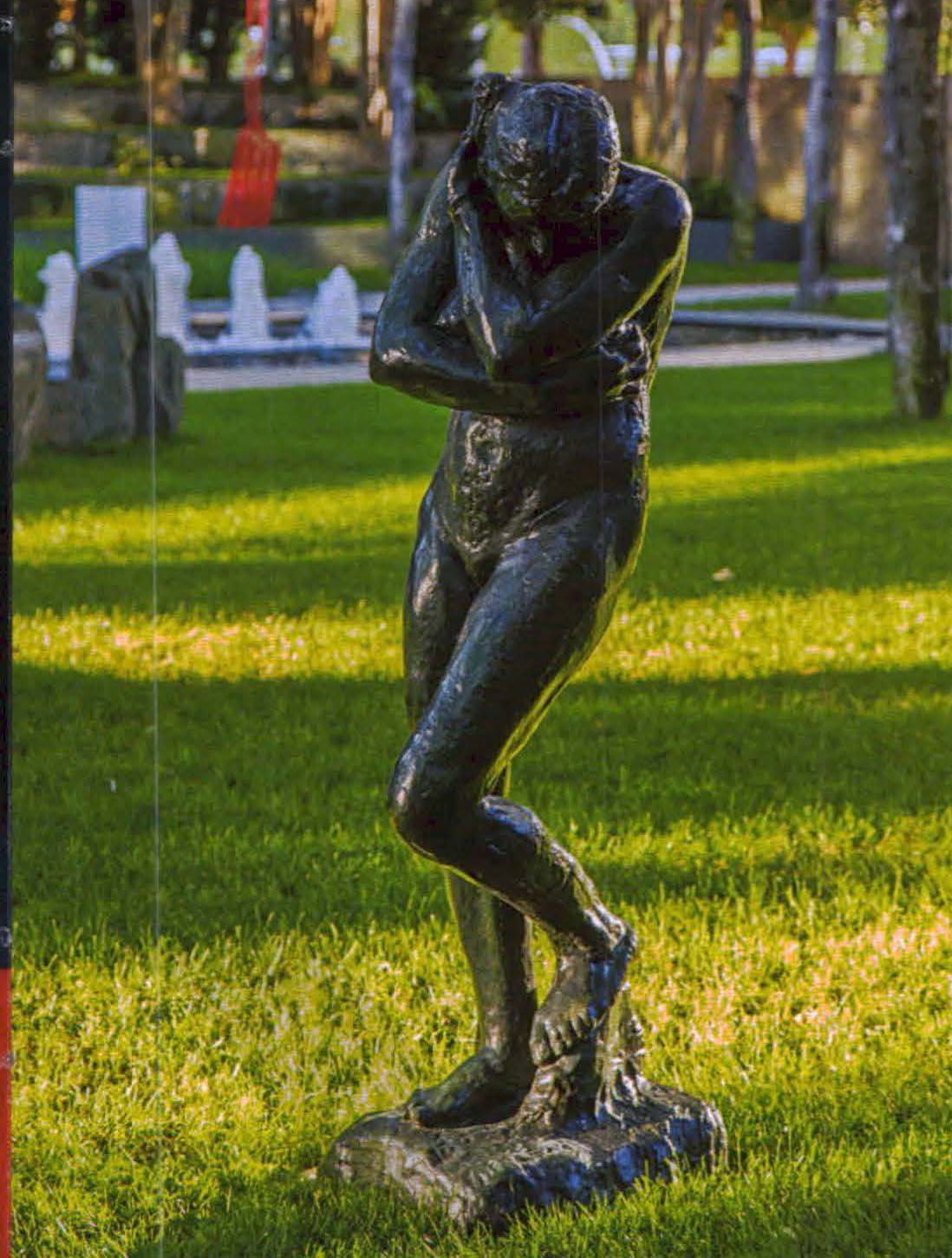 A statue in a green garden