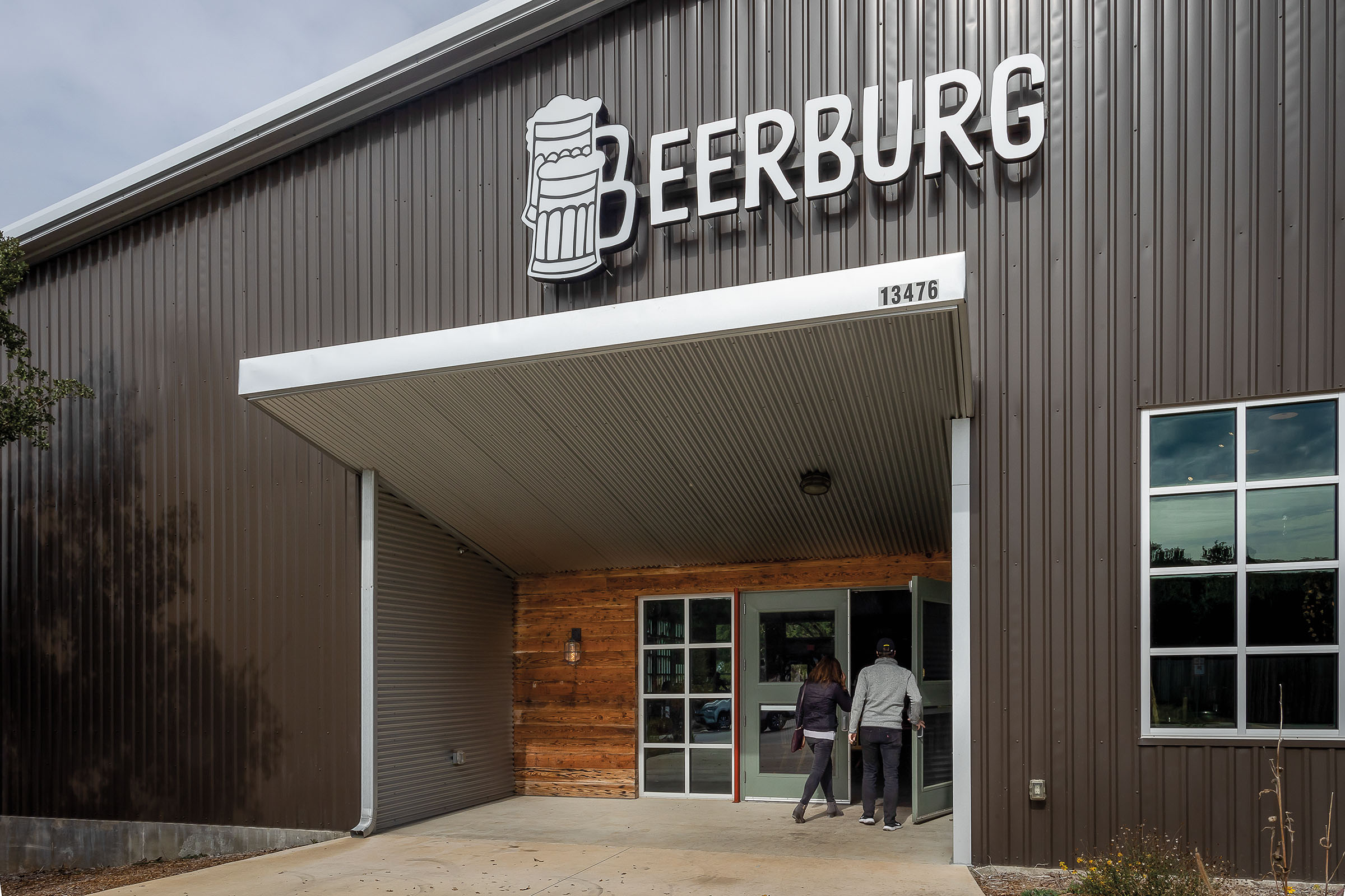 The outside of a gray building with a large sign reading "Beerburg"