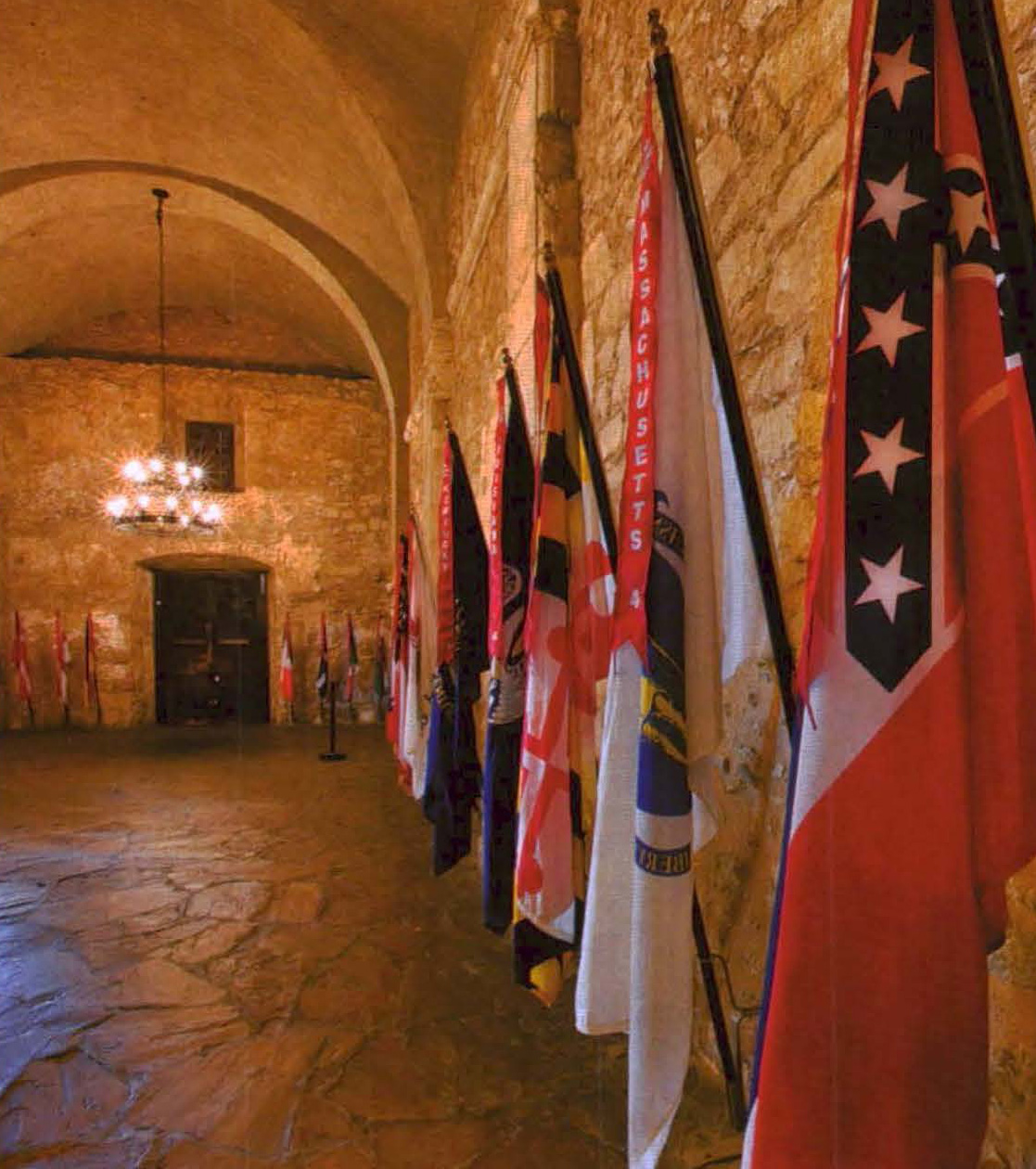 Flags hang along stone walls of a building