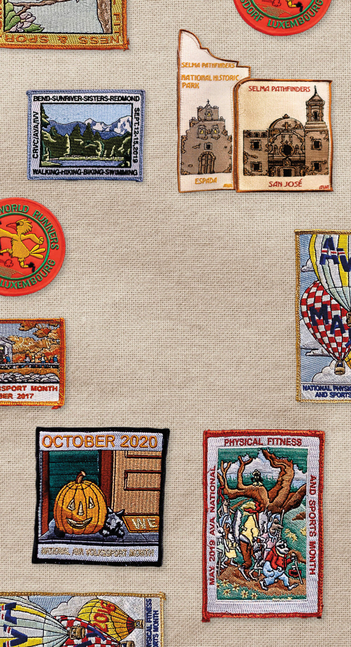 A photo of several brightly-colored sewn patches on a burlap background
