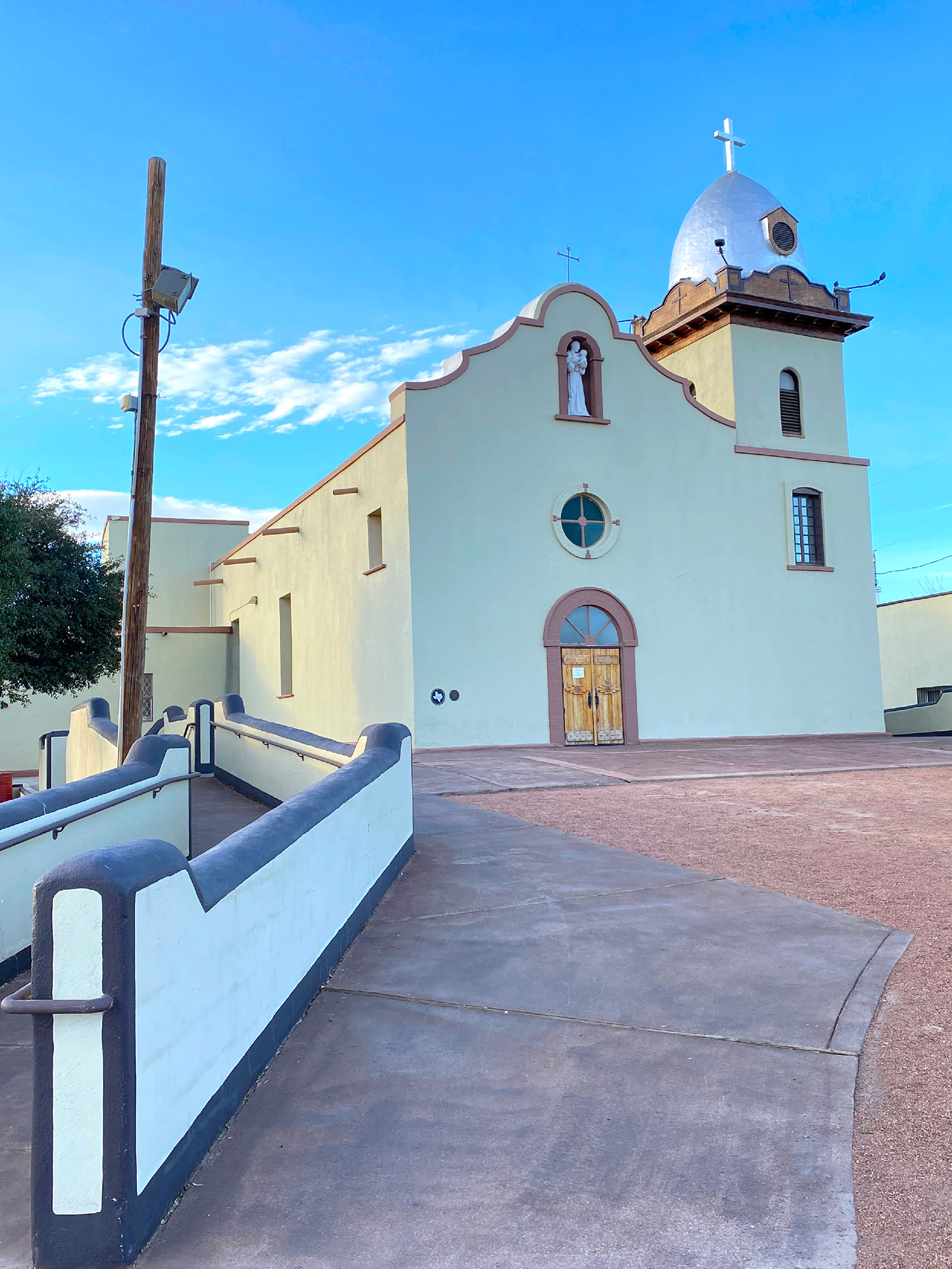 The Ysleta del Sur Mission stands at the end of a terra cotta-colored pathway