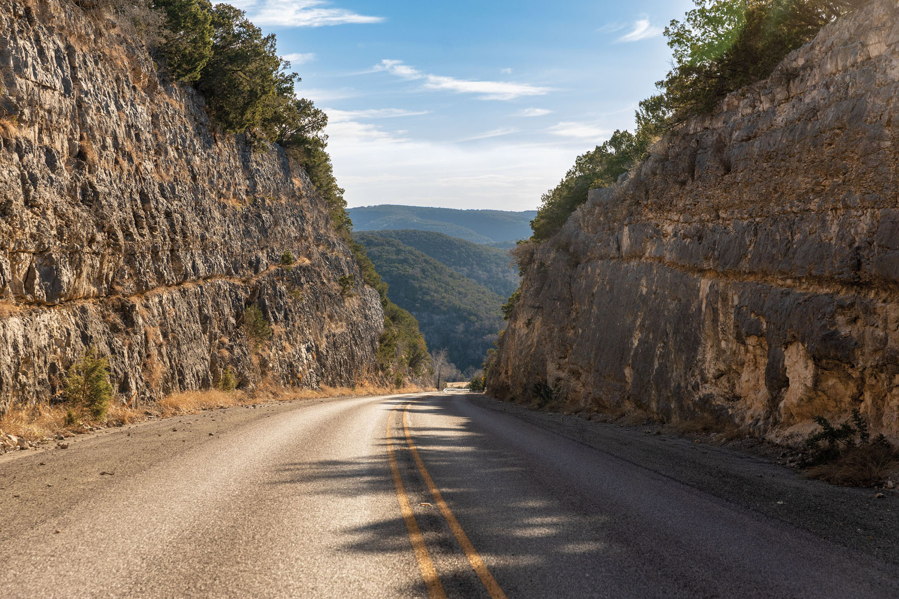 A picture of a road sandwiched between two large rock columns