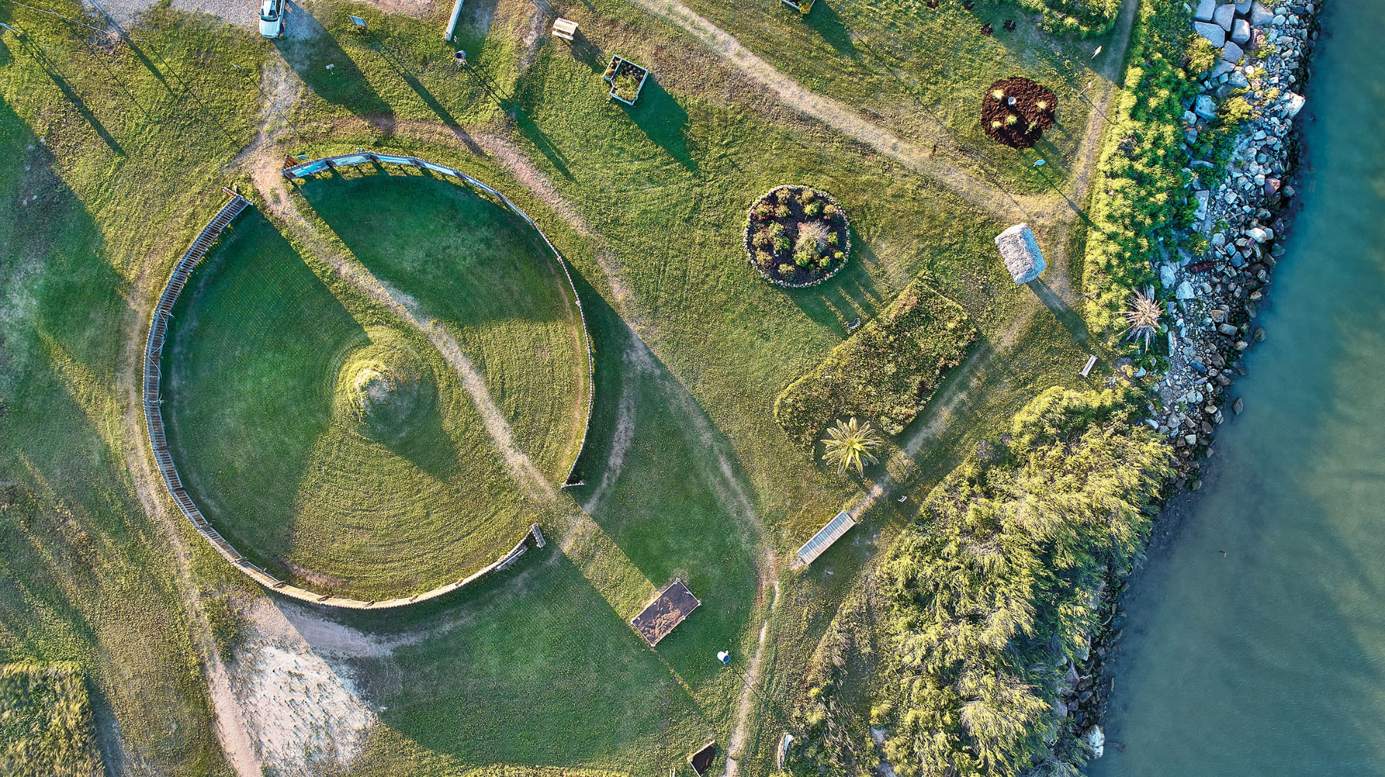 An overhead view of green fields and gravel roads