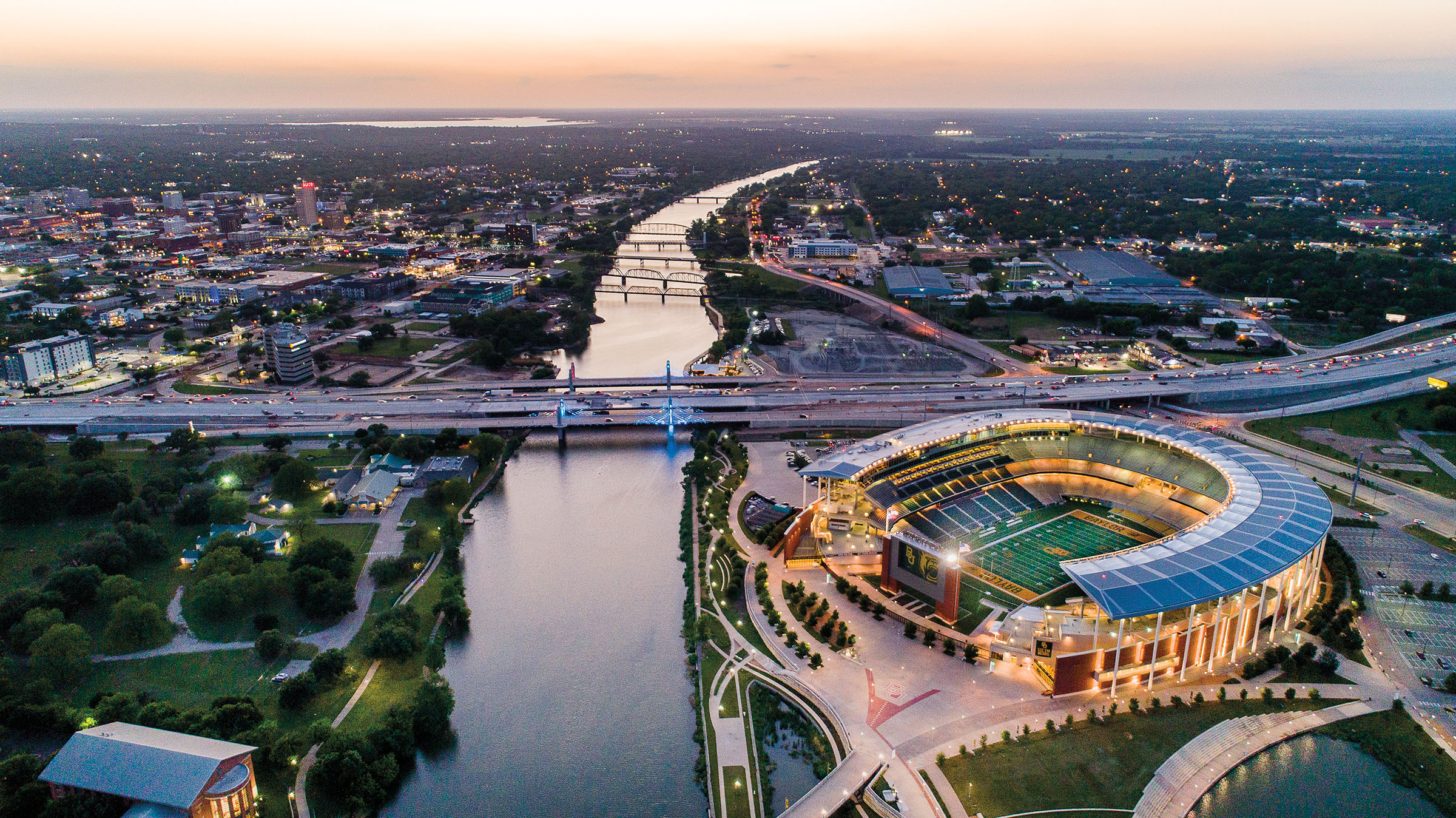 An overhead view of Waco, with Baylor stadium on the right and the Brazos river separating two sides of the city