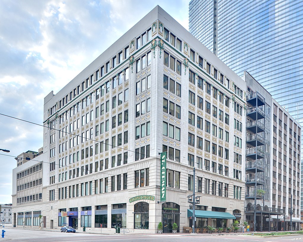 The exterior of a building with many floors of large windows and a green sign reading "St.Germain"