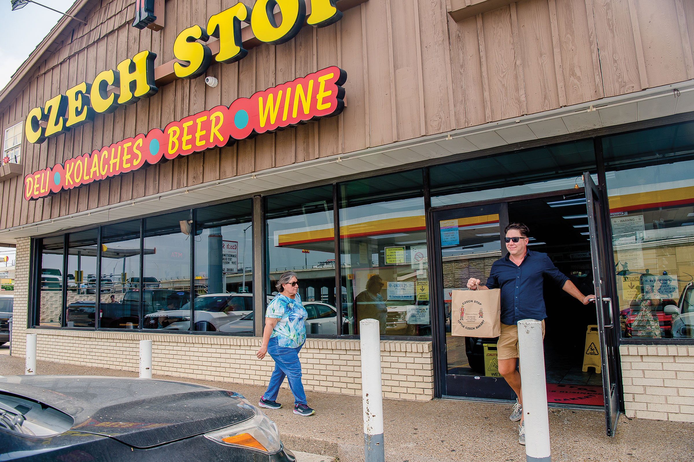 The exterior of a wooden building with bright yellow letters reading "Czech Stop"