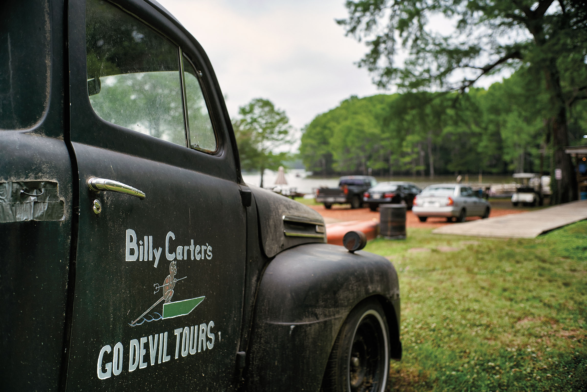 The outside of a dark truck painted with words reading "Billy Carter's Go Devil Tours"