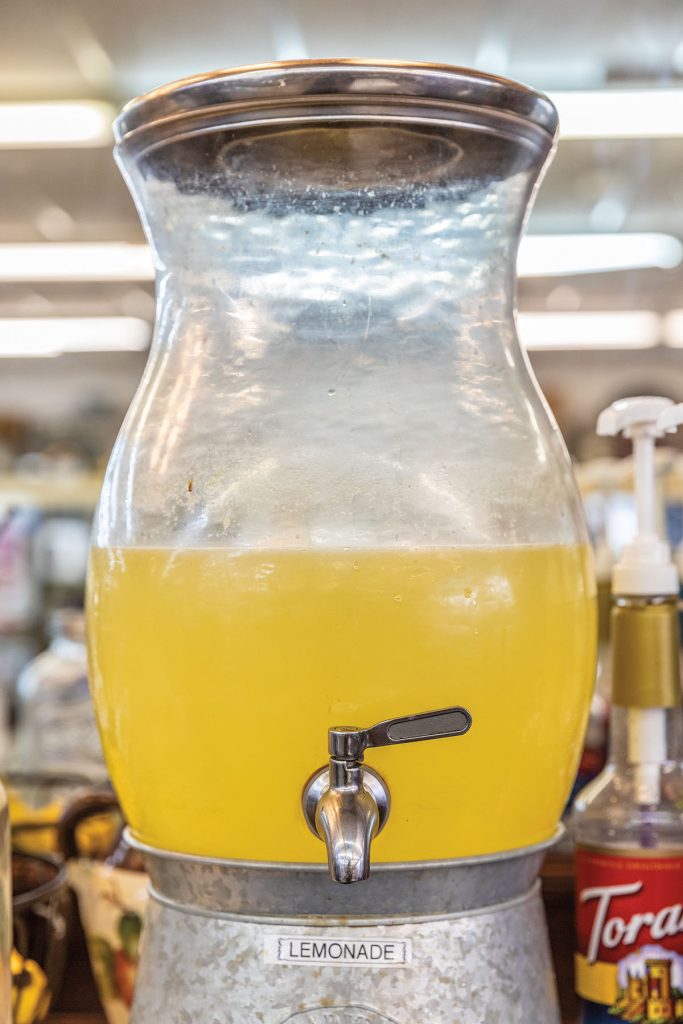 A container of bright yellow lemonade inside of a store