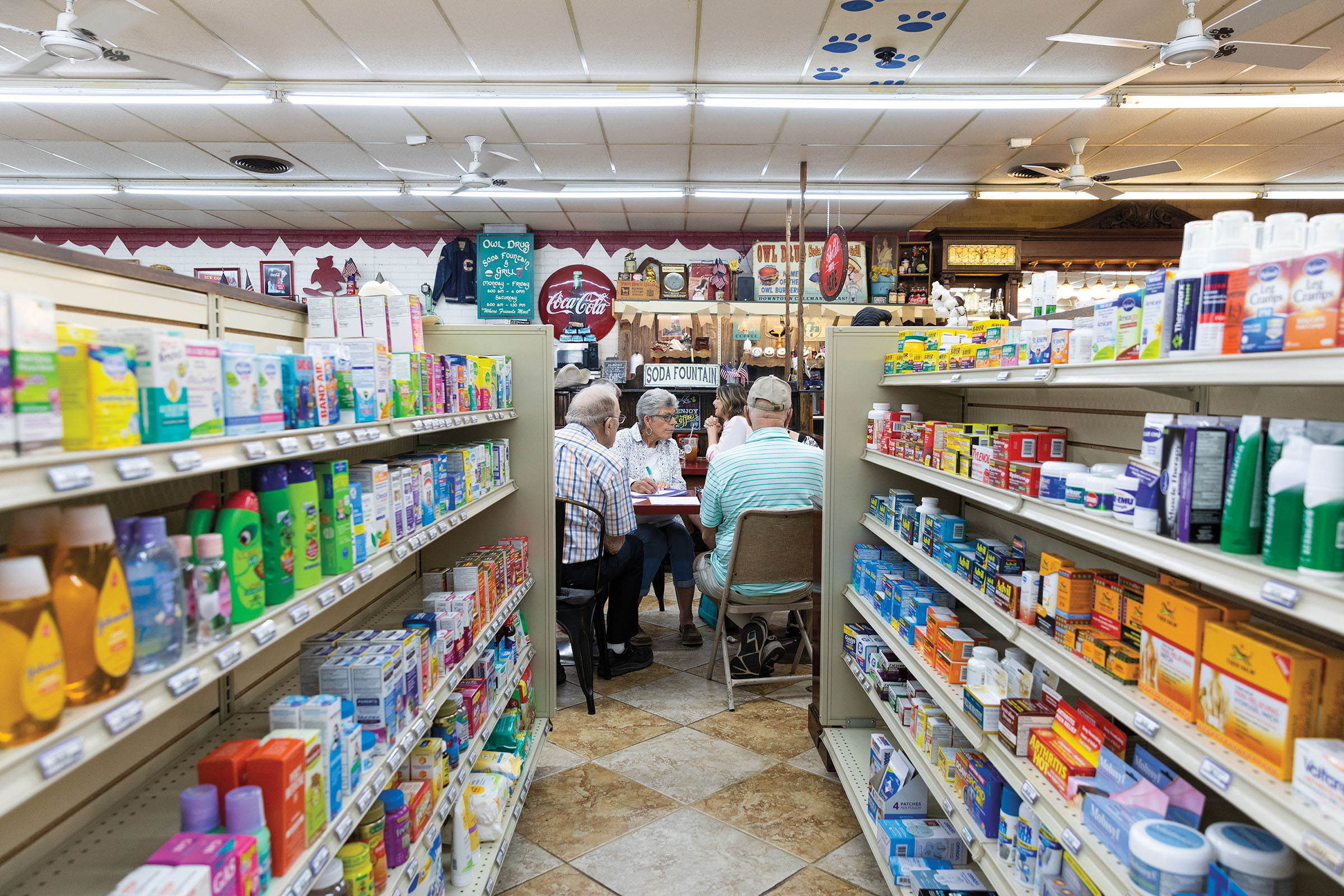 A table of people inside of a drugstore