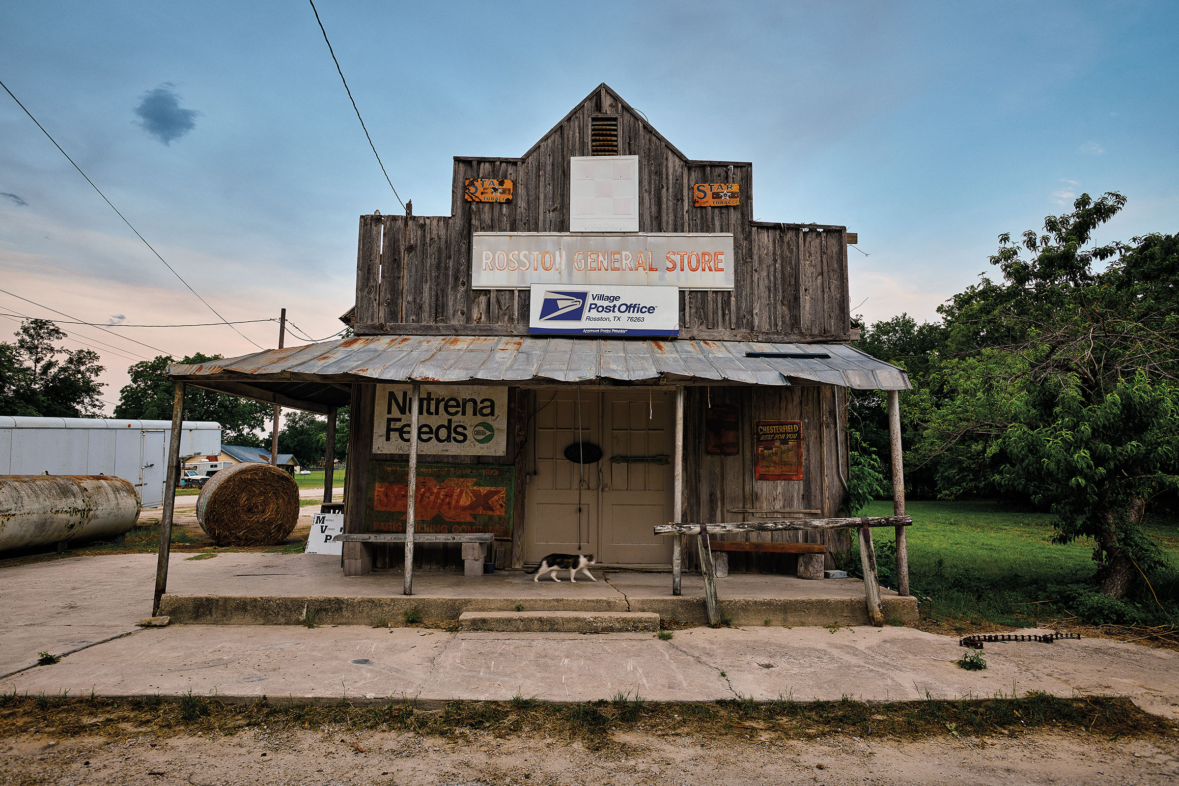 The exterior of a wooden post office under ablue sky