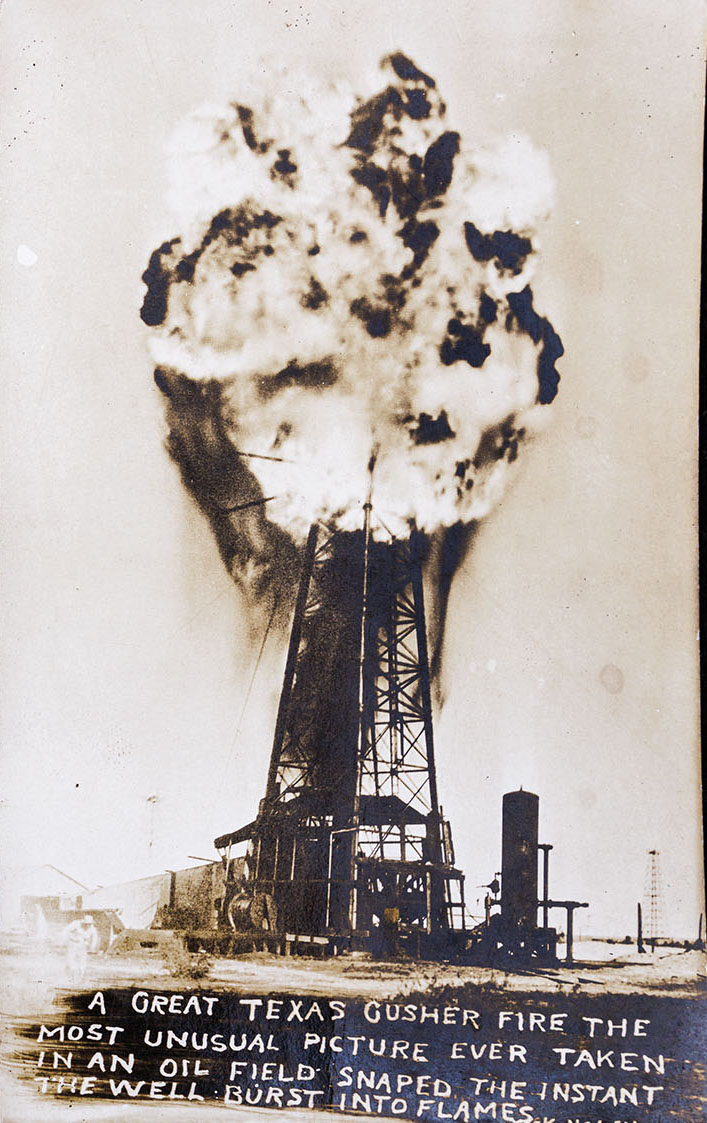 A vintage photo of a large oil derreck with a huge plume of smoke above