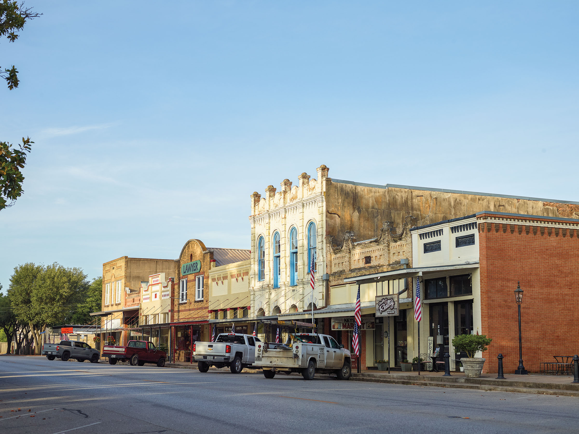 Brick buildings line a downtown street under blue sky