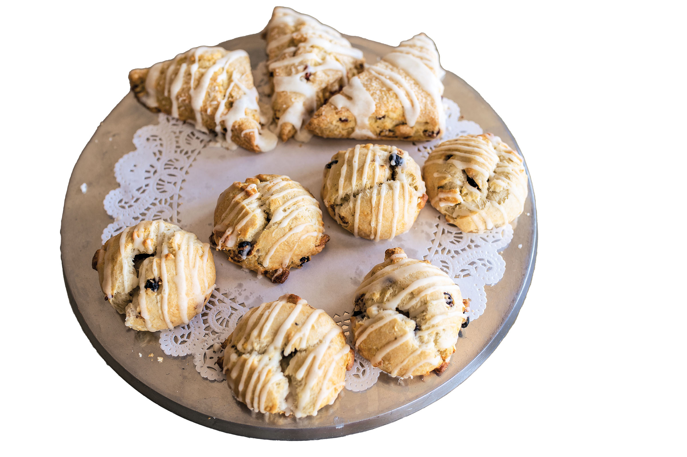 A platter of scones with light stripes of icing