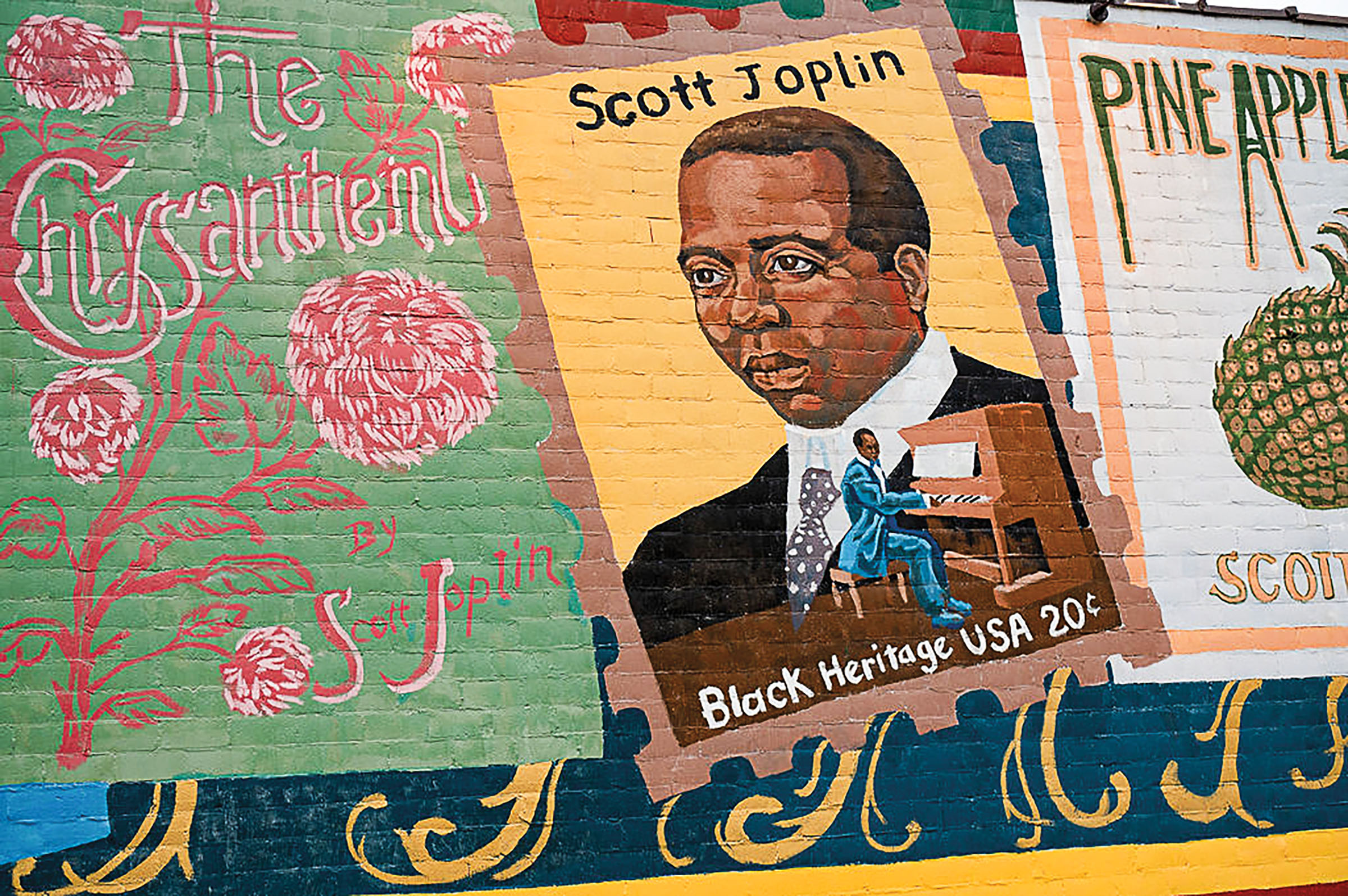 A mural with Scott Joplin and brightly colored flowers and flourishes