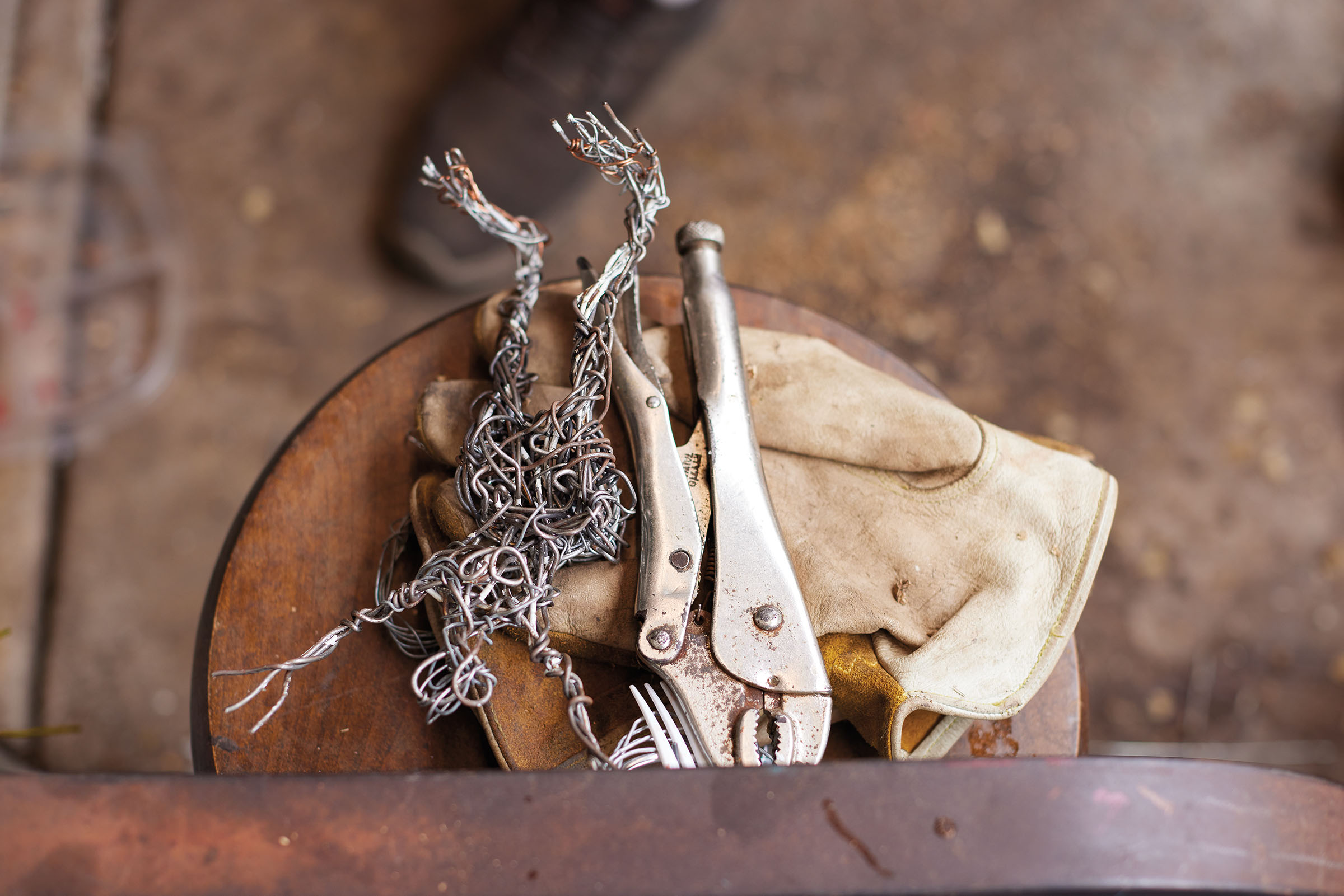 A collection of tools and metal waiting to be used in a sculpture