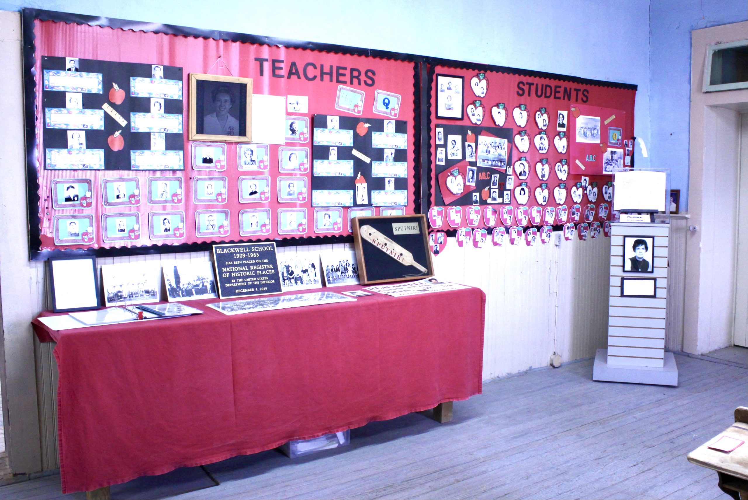 a red table and red bulletin boards