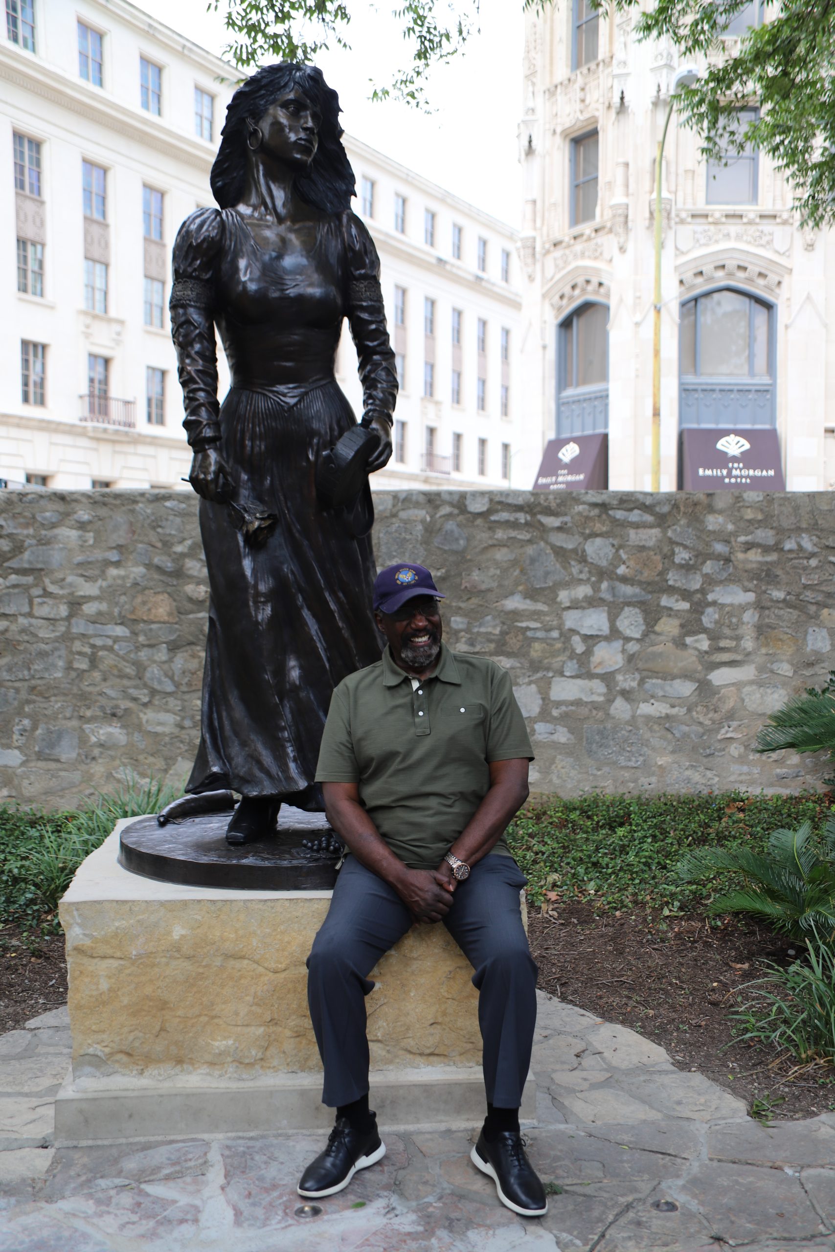 Sculptor Eddie Dixon sits at the base of the Emily West Morgan statue he created for the Alamo. Photo courtesy the Alamo Trust, Inc.