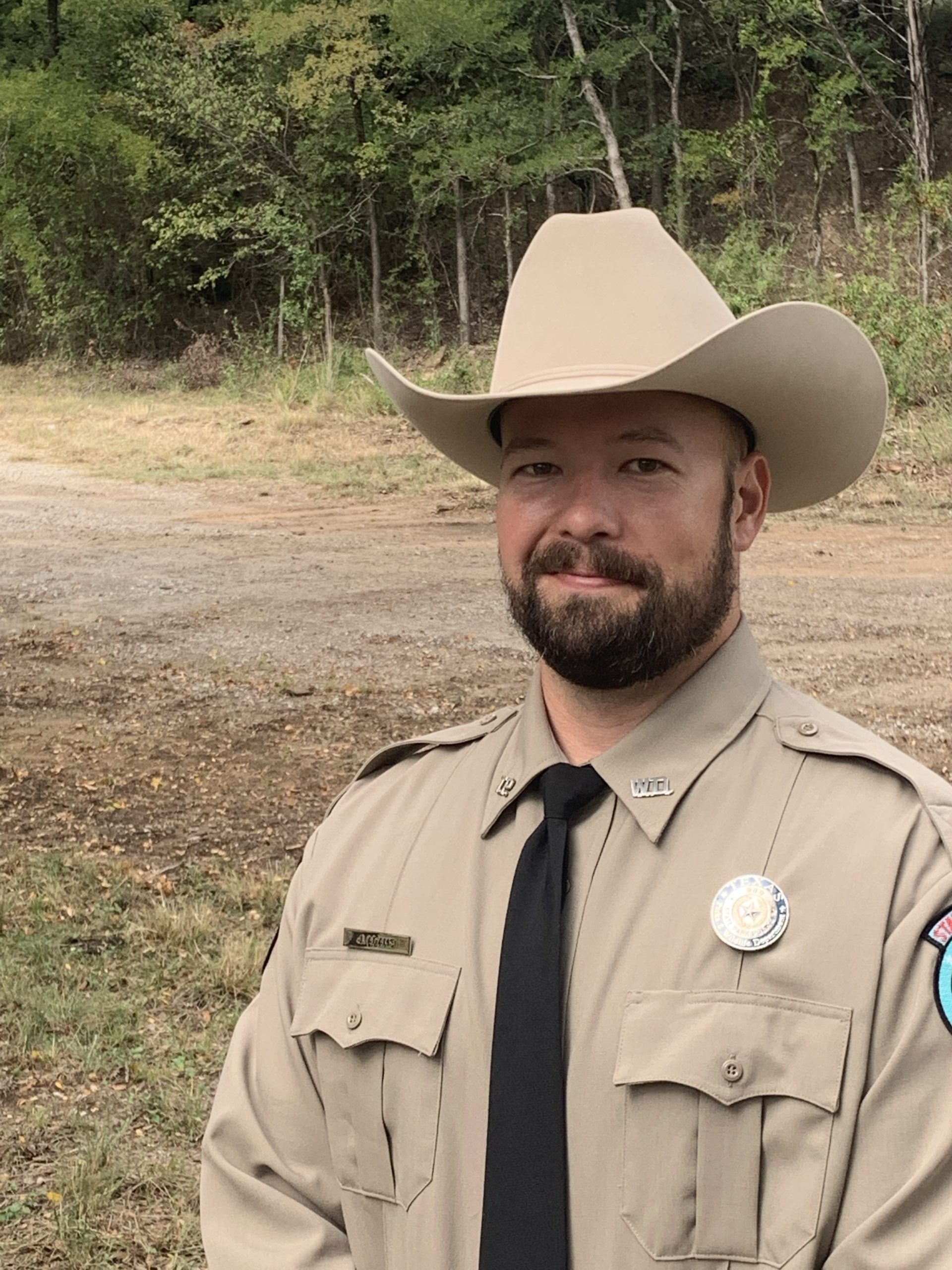 James Adams wears a cowboy hat and the khaki uniform of Texas Parks and Wildlife