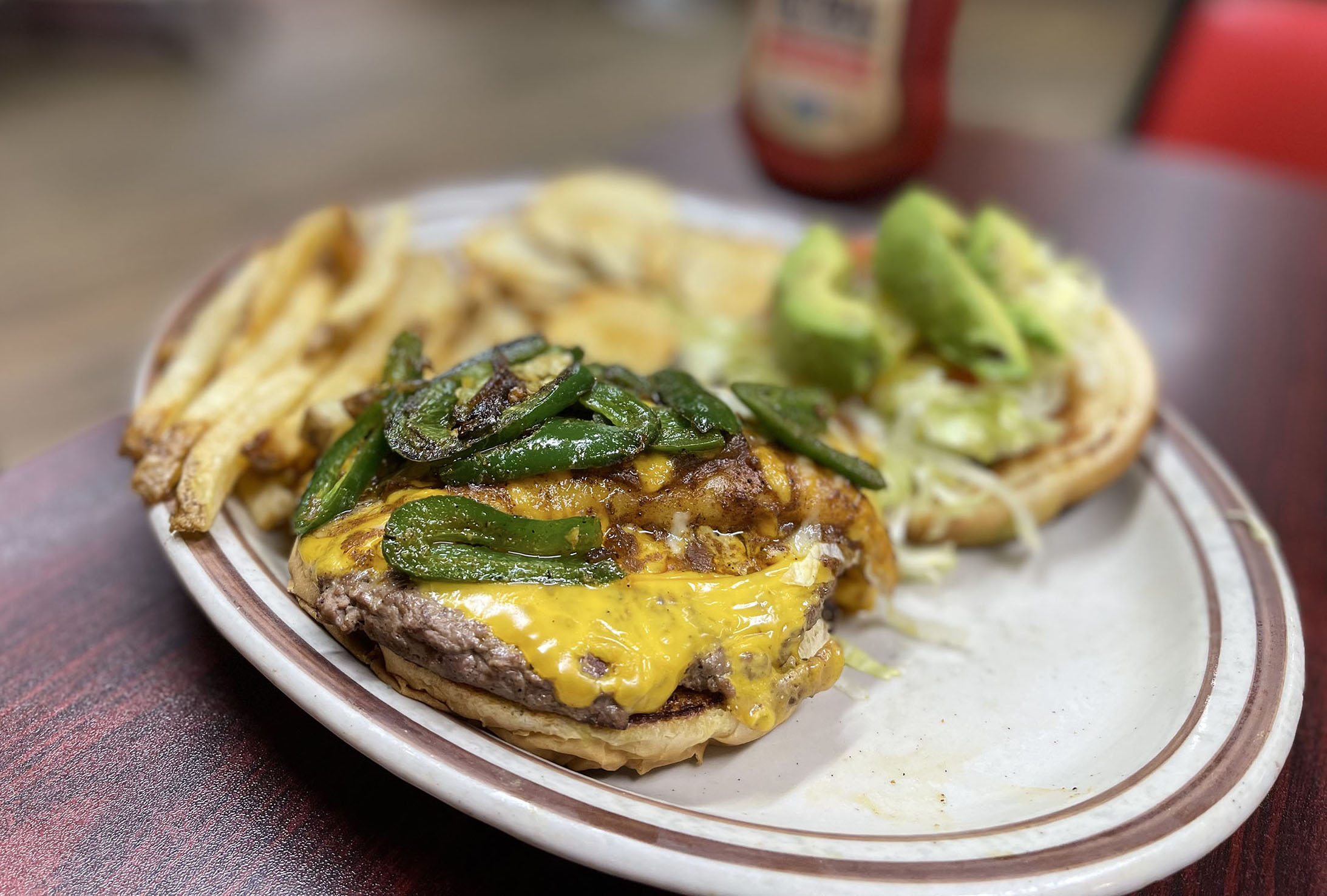cheeseburger with an enchilada and jalapeños